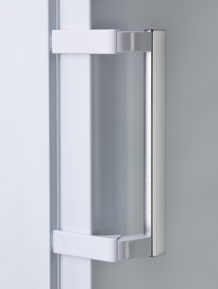 Close-up of a white refrigerator handle with a silver bar.