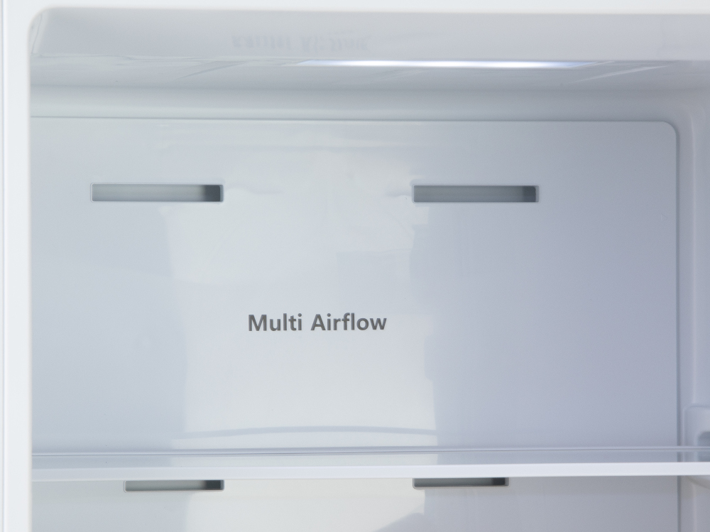 Refrigerator interior. White shelves, with the words 'Multi Airflow'. Top and bottom vents visible.
