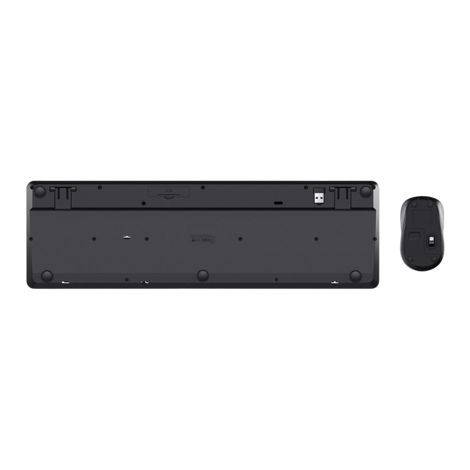 The underside of a black keyboard and mouse. The keyboard has feet and the mouse has a battery compartment.