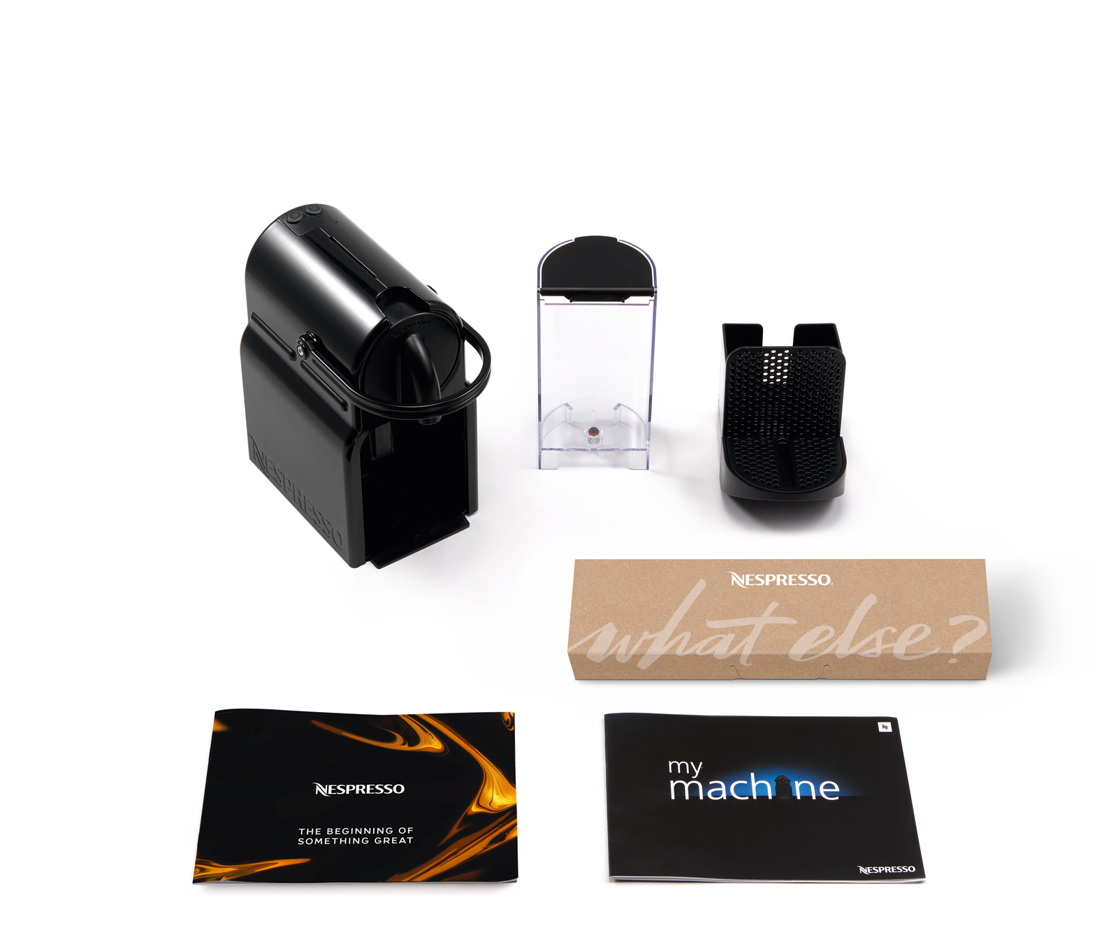 Pièces de machine Nespresso noire. Machine, réservoir d'eau, porte-capsules et manuels.