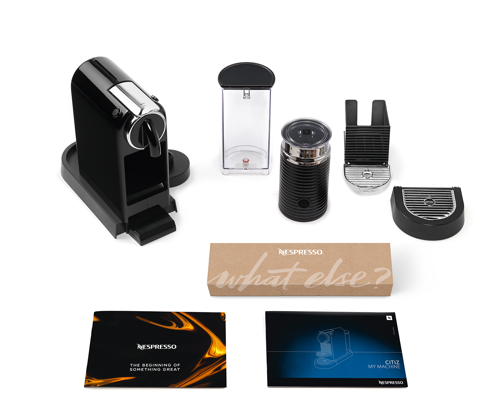 A Nespresso coffee machine with accessories, including a box and instructions.