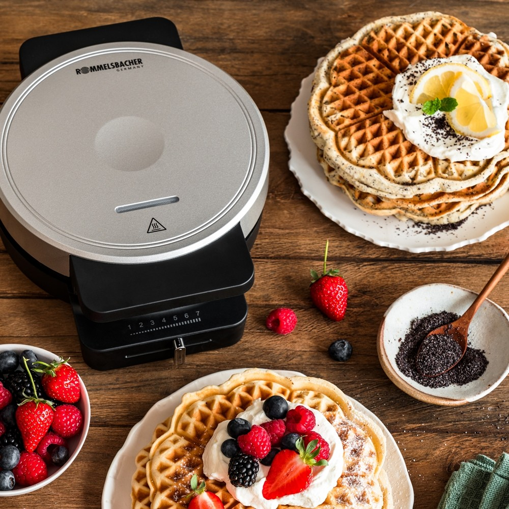 Waffeleisen, Waffeln mit Sahne und Beeren, Beeren-Schüssel, Mohnsamen-Schüssel, Zitrone, Holzlöffel, Erdbeeren, Blaubeeren, Himbeeren.