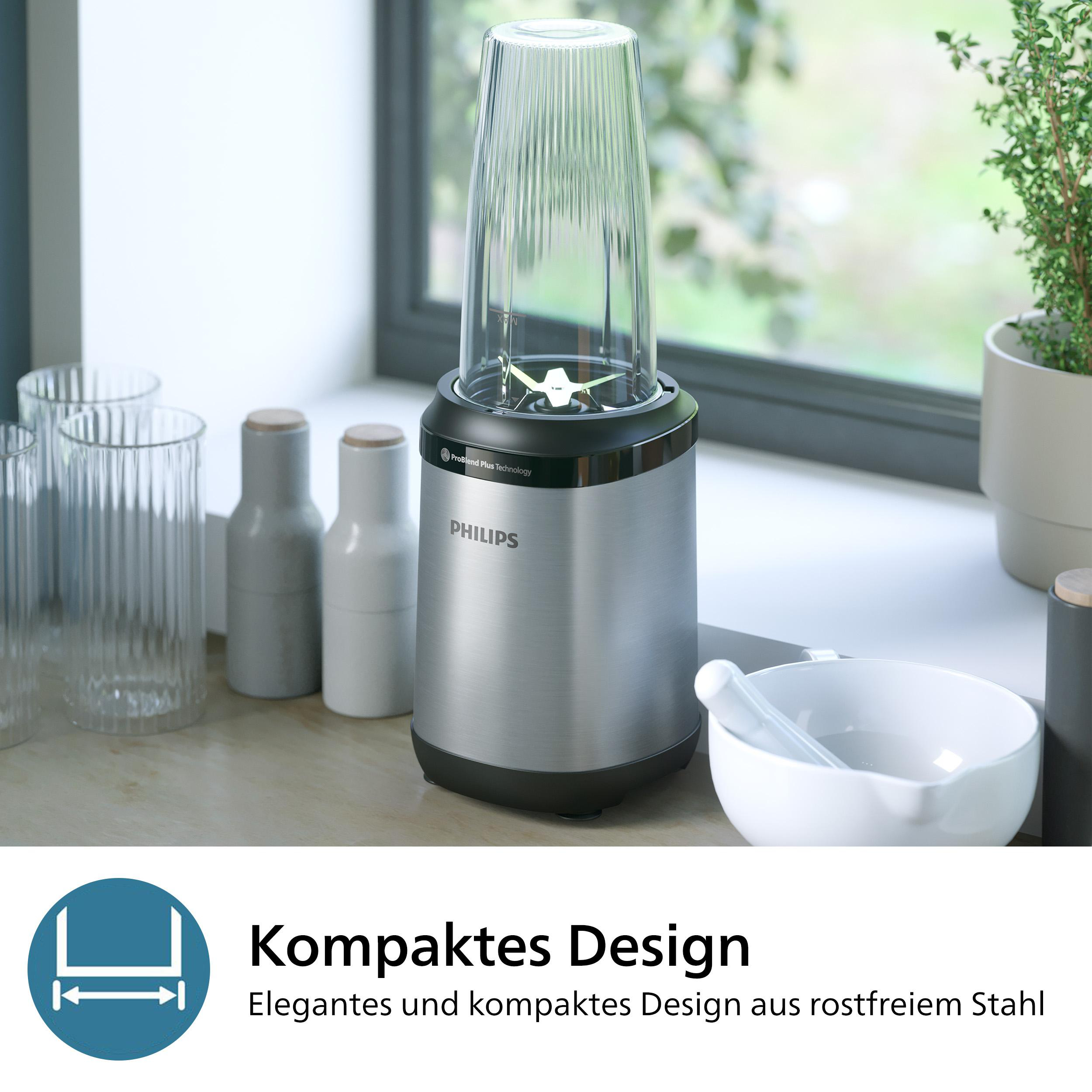 Silberner Philips-Mixer mit Glasbehälter, in der Nähe eines Fensters mit anderen Objekten.