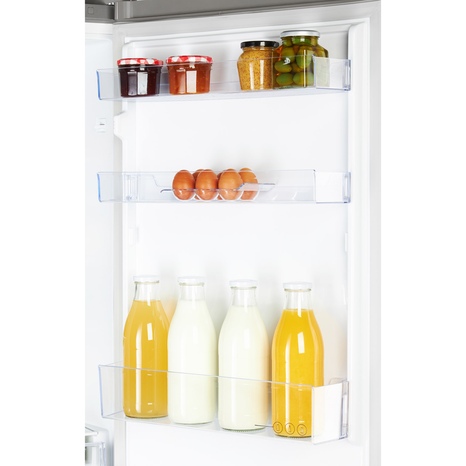 Refrigerator shelves with jars, eggs, and juice bottles.