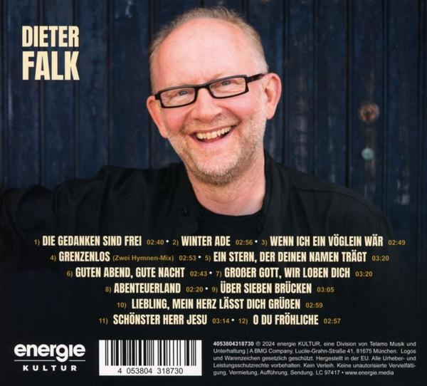 Das Albumcover zeigt einen lächelnden Mann mit Brille, Songtiteln und einem kulturellen Logo.