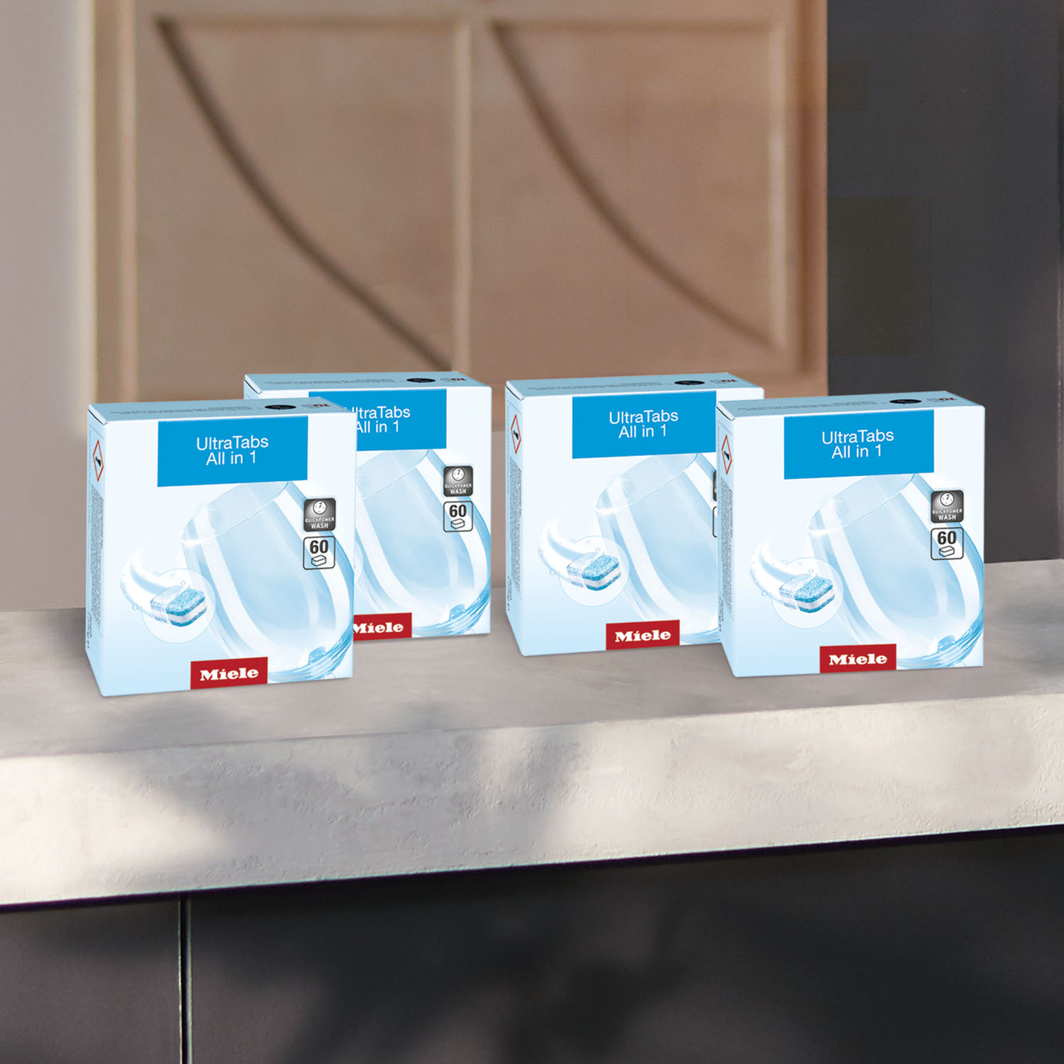 Quattro scatole di detersivo per lavastoviglie Miele UltraTabs All in 1 su un bancone.