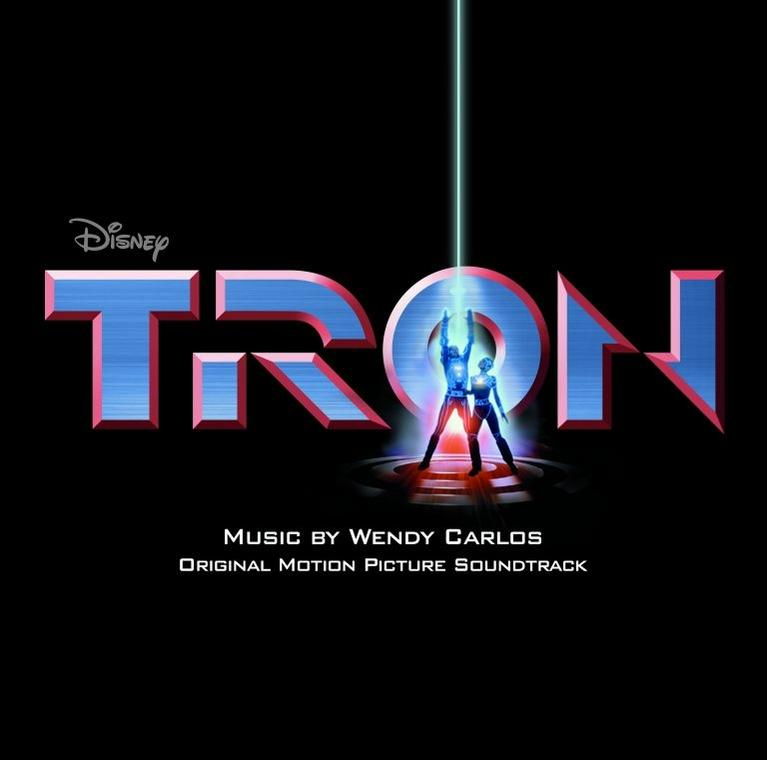 A Disney Tron című filmjének plakátja neon logóval és két figurával. Fekete háttér.