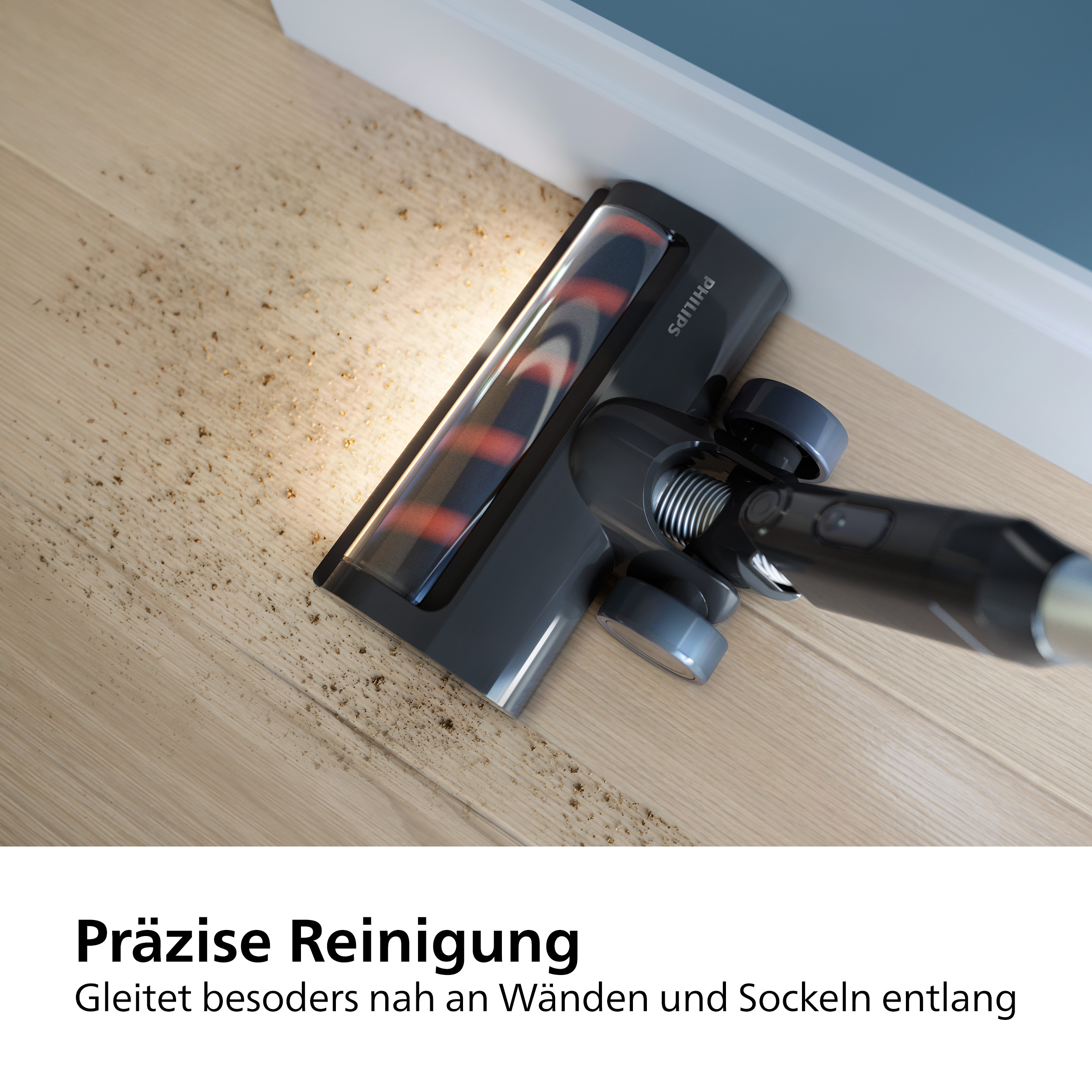 Staubsaugerkopf reinigt den Boden. Rote und schwarze Bürste, auf hellem Holzboden, weißer Rahmen.