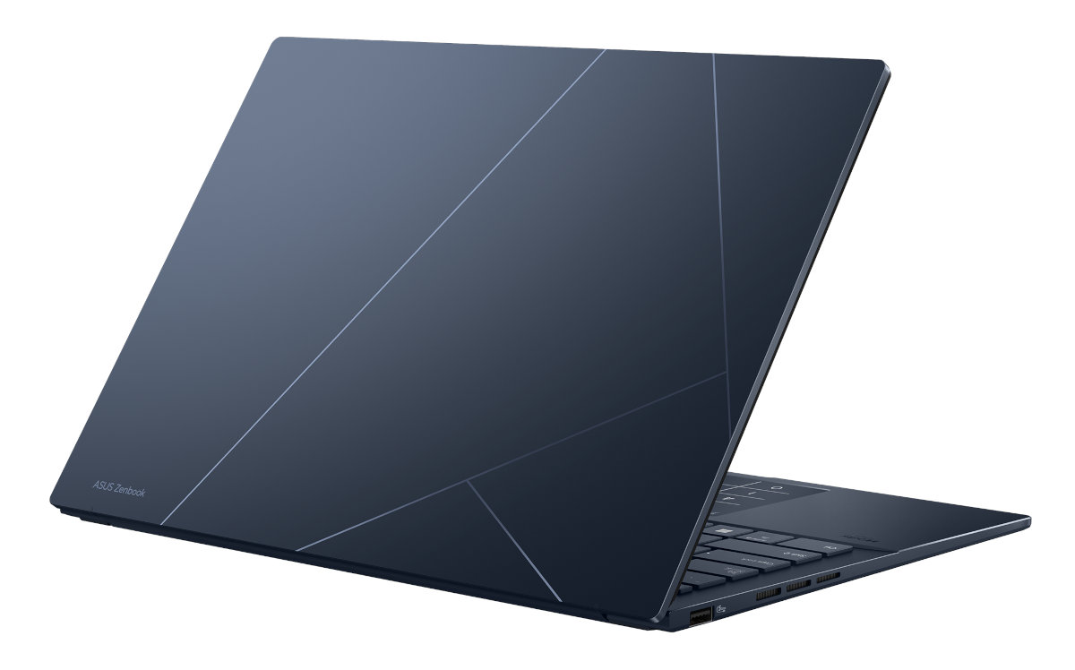 Ciemnoniebieski laptop ASUS Zenbook, otwarty pod kątem, pokazujący tył z geometrycznym wzorem.