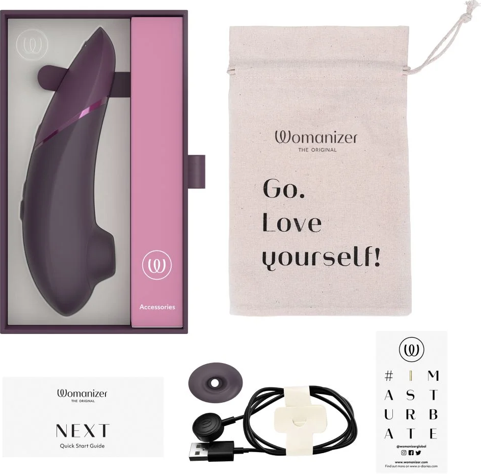 Appareil Womanizer Next dans une boîte avec accessoires, un sac et des instructions.