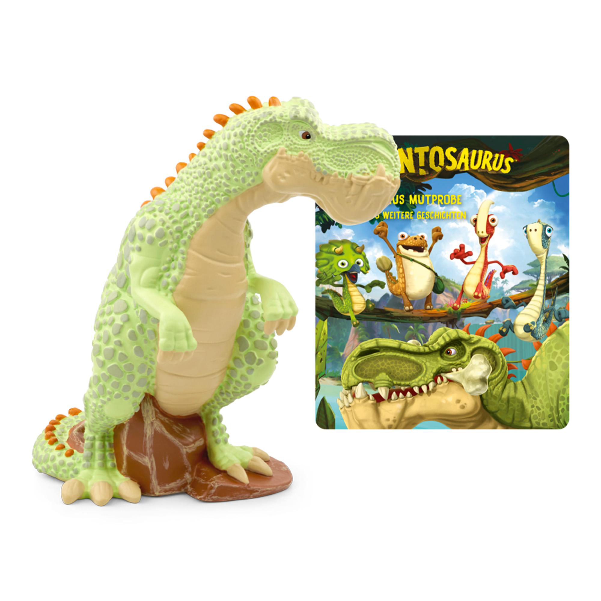 Ein grünes Dinosaurierspielzeug neben einem Buchcover mit Zeichentrickdinosauriern. Der Hintergrund ist weiß.