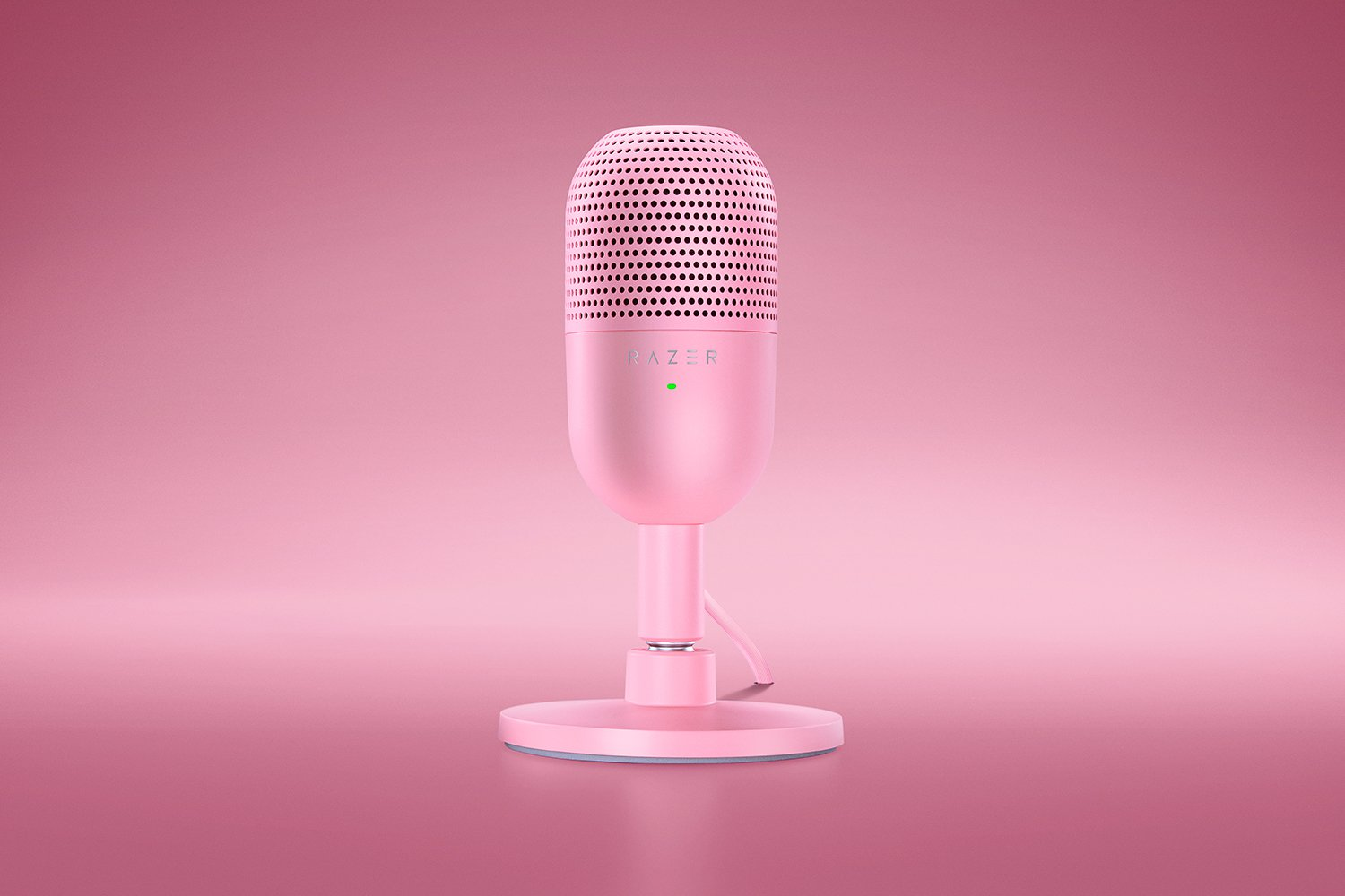 Un microfono Razer rosa su una superficie rosa. Il microfono è al centro, lo sfondo è sfocato.