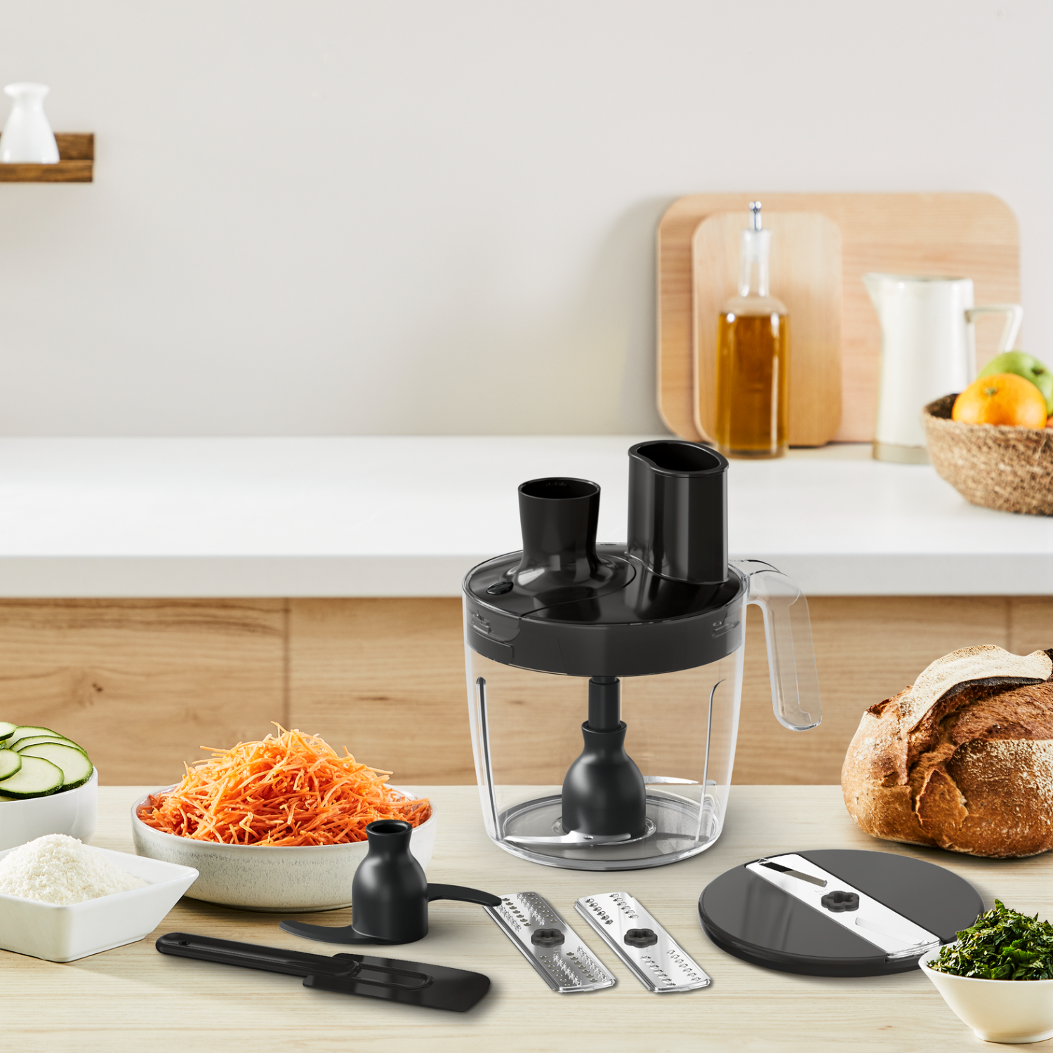 A food processor with various attachments and ingredients on a wooden countertop.