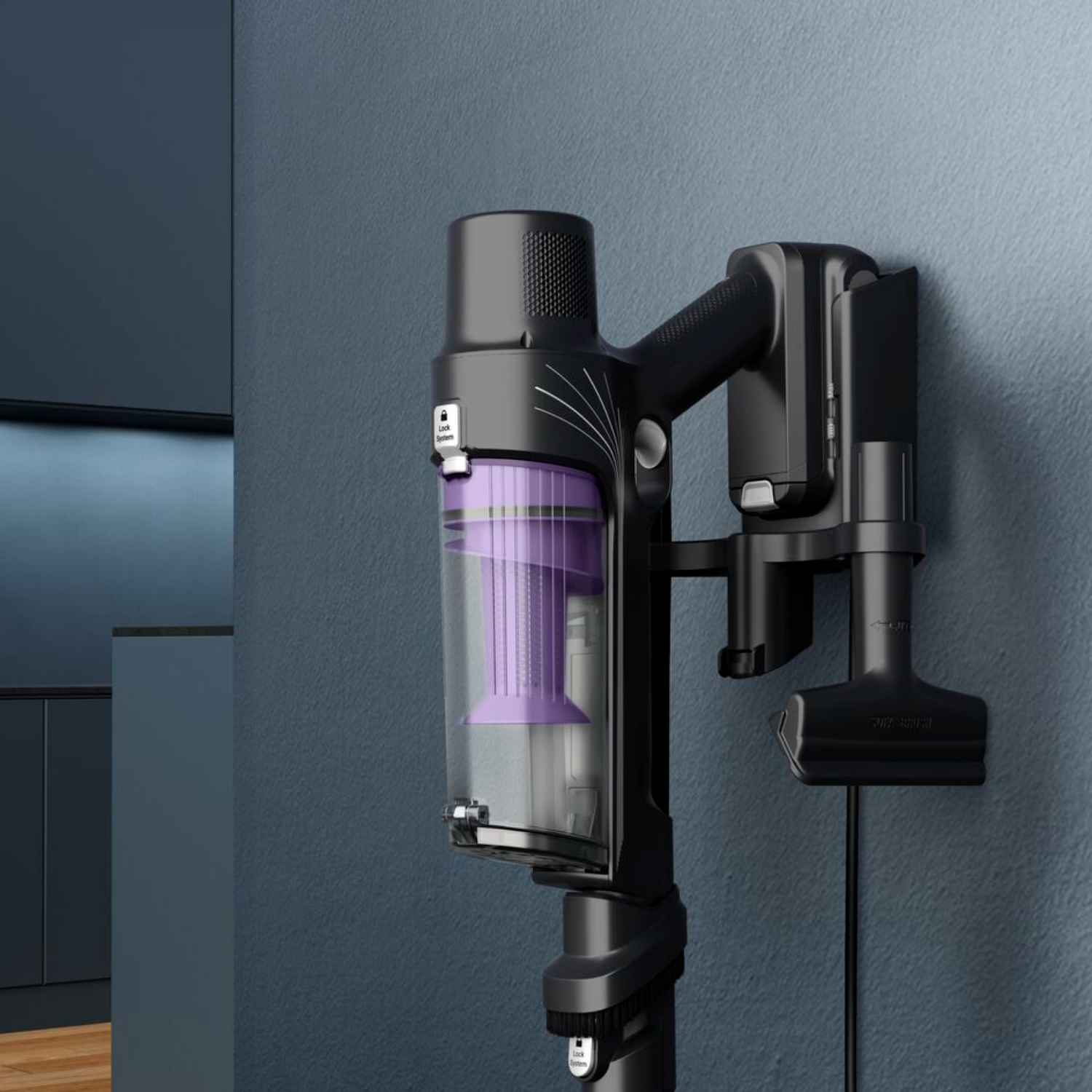 Black cordless vacuum cleaner mounted on a wall. It has a purple filter and brush.