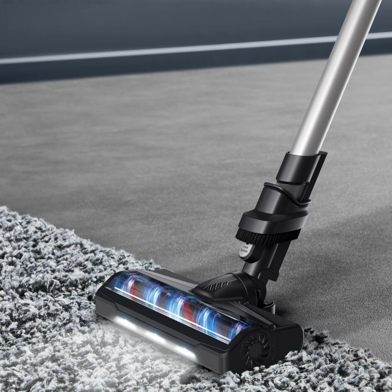 A vacuum cleaner head cleaning a gray carpet. The brush and lights are visible.