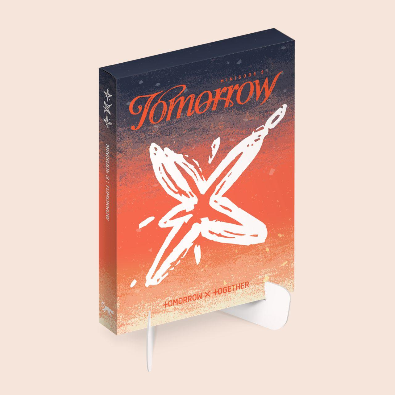 Boekomslag van TXT's album, met Tomorrow-titel en ster grafiek, op een standaard.