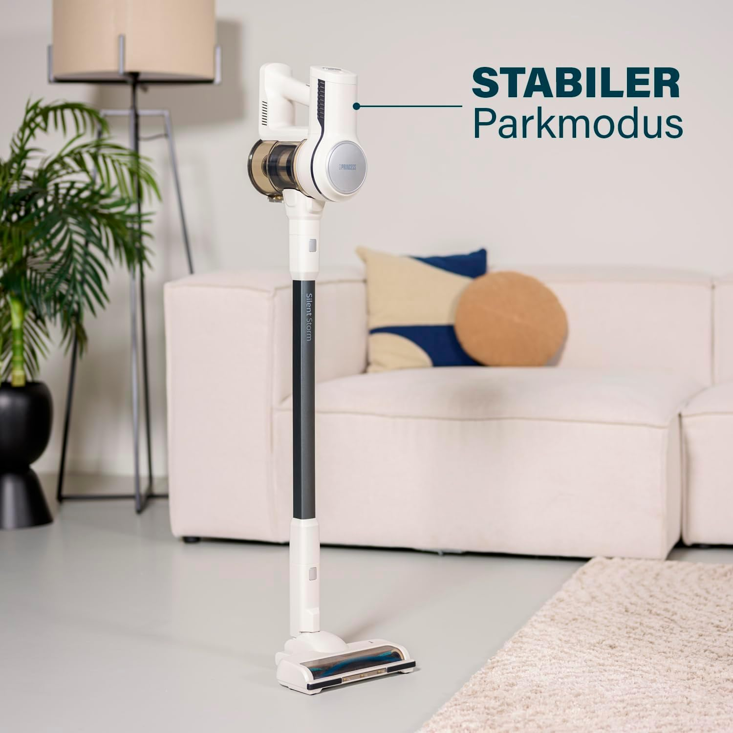Aspirapolvere bianco e oro con supporto. Testo: 'STABILER Parkmodus'.