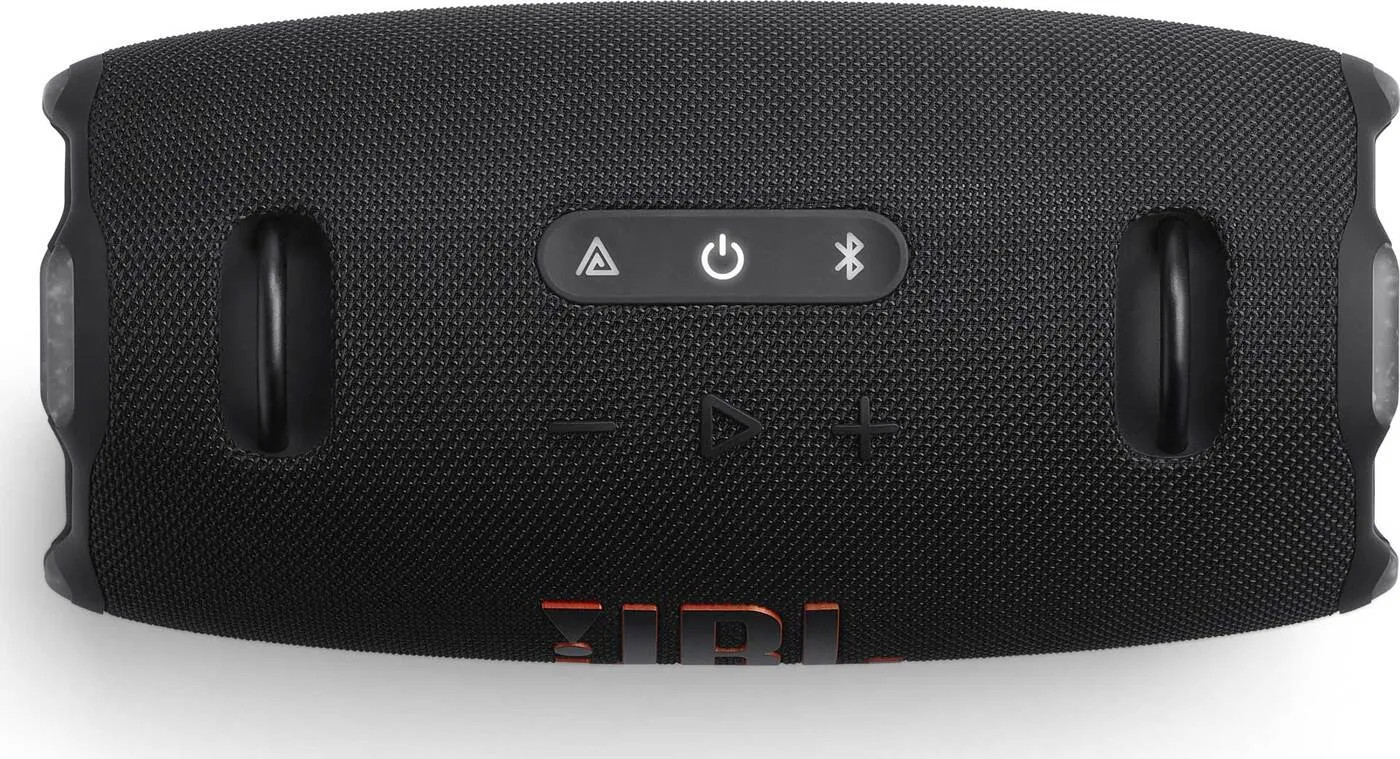 Czarny głośnik JBL z przyciskami na górze. Logo JBL jest pomarańczowe.