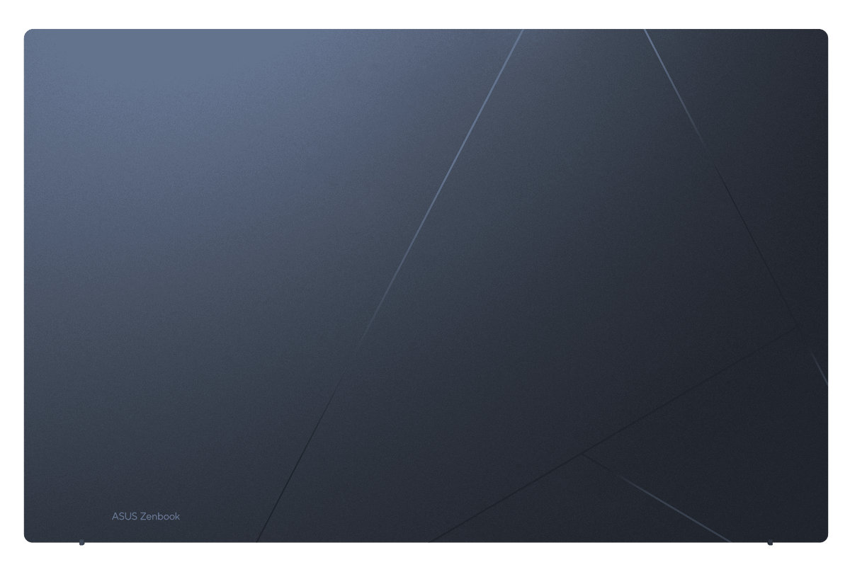 Górna część granatowego laptopa z geometrycznym wzorem. Tekst 'ASUS Zenbook' jest na dole.