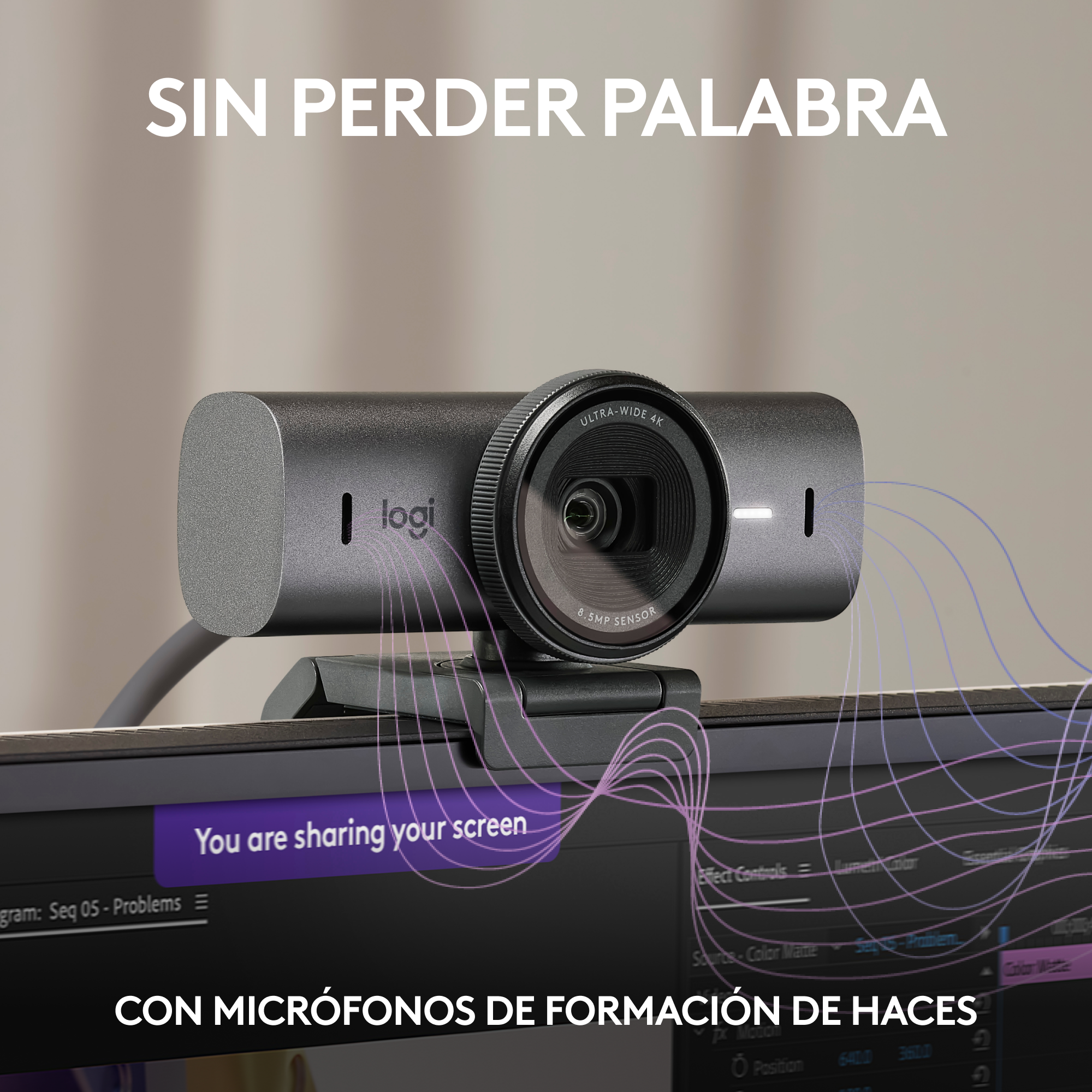 Una webcam gris en un monitor, con texto en español e inglés sobre compartir la pantalla.