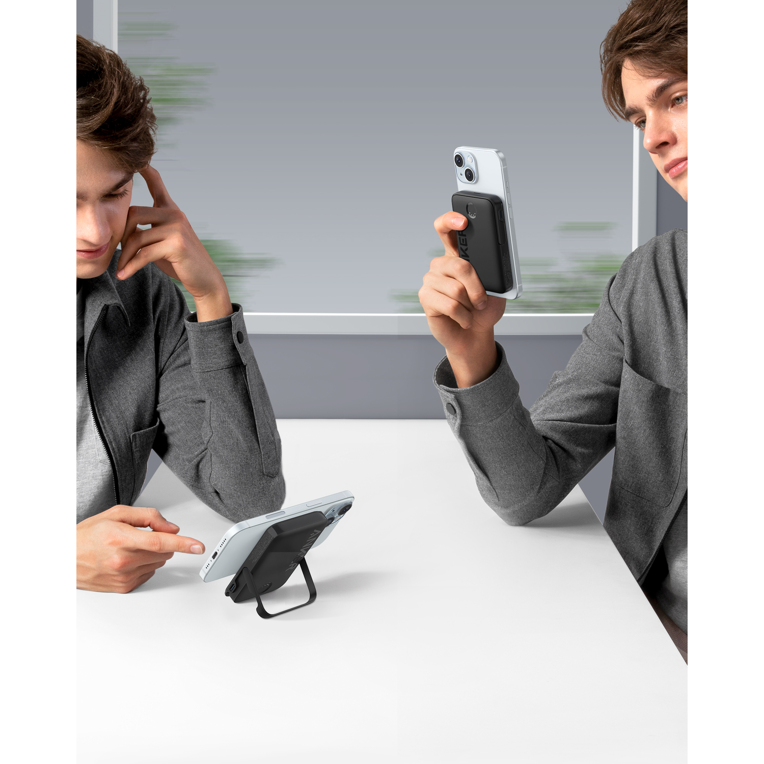 Two men looking at a phone. One holds the phone with a black case, other points.