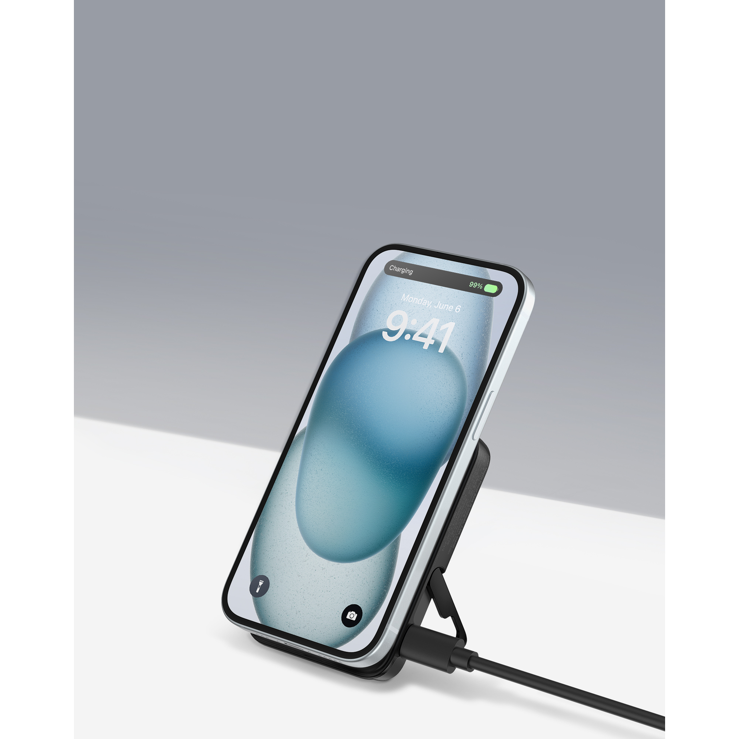 Phone charging on a wireless stand. Shows 99% battery.