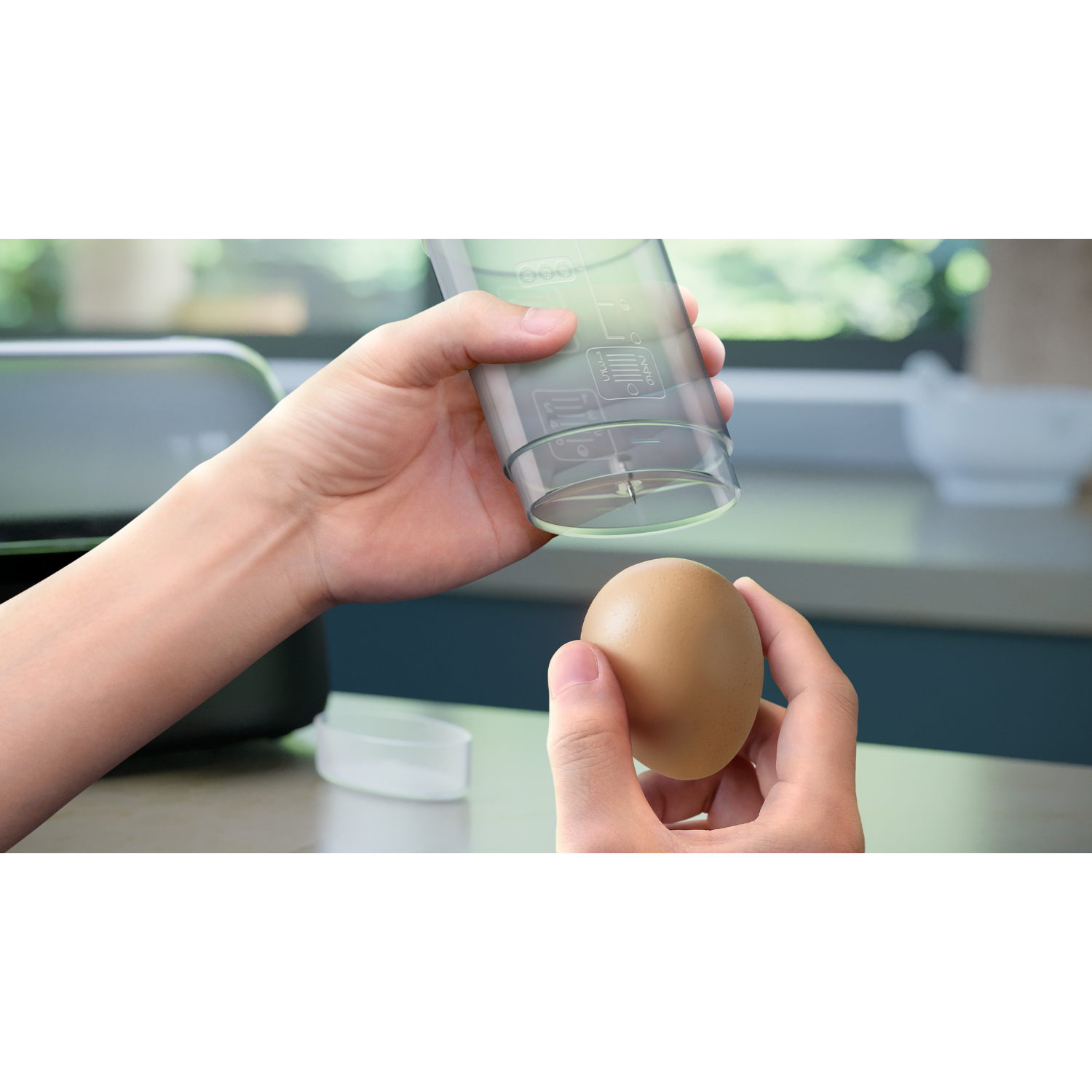 A person holding an egg and an egg separator, ready to separate the egg.