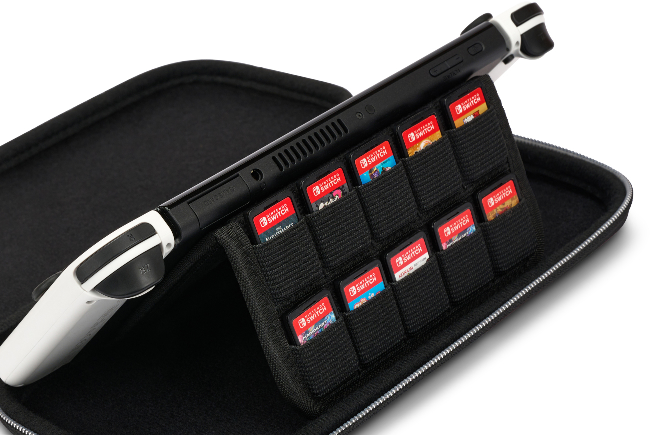 Egy fekete Nintendo Switch konzol játékkazettákkal egy tokban. Fehér Joy-Cons csatlakozik hozzá.