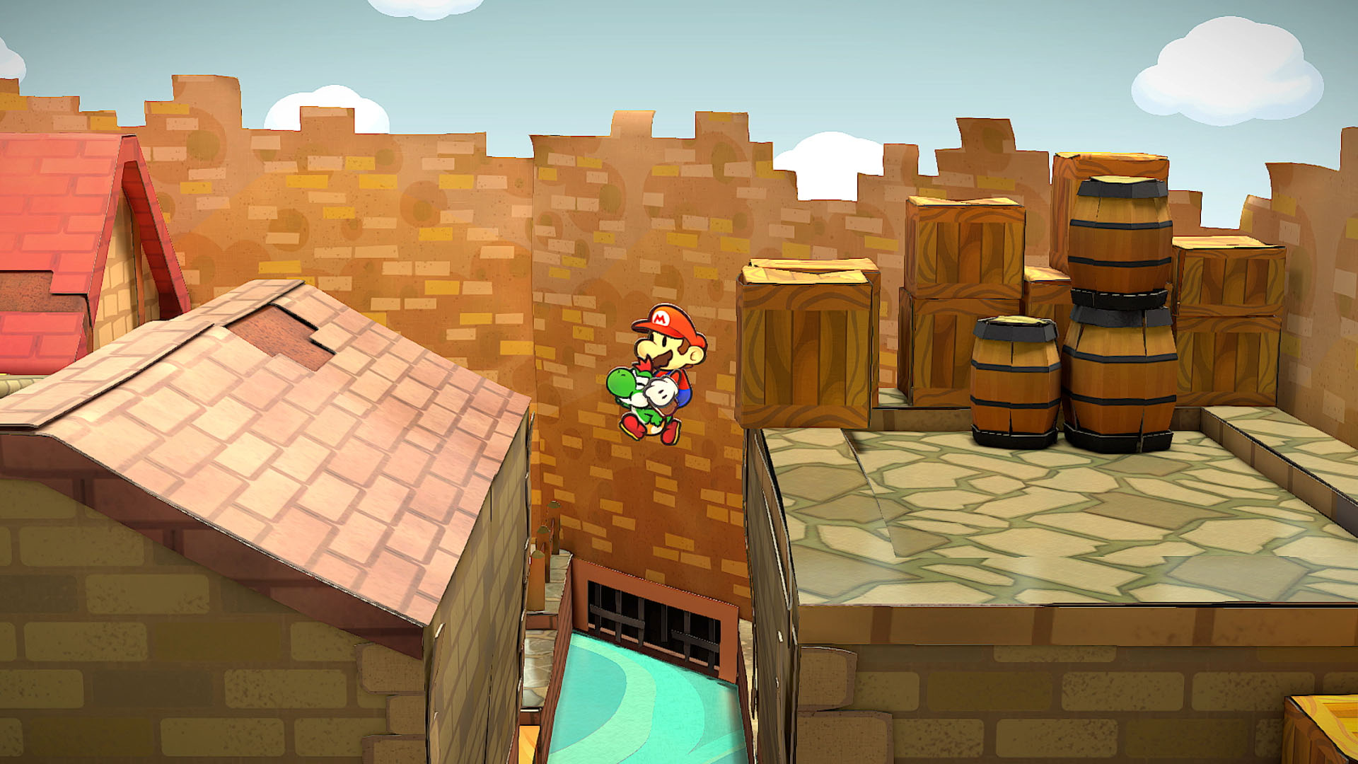 Paper Mario e Yoshi saltano sopra un vuoto in una città di carta con casse e un muro.
