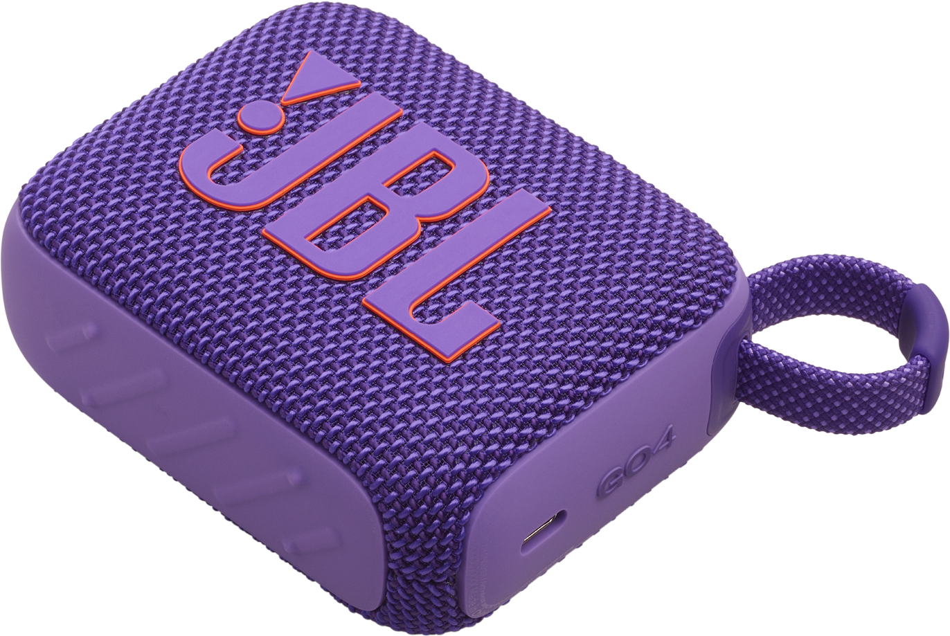 Un altoparlante JBL viola con una copertura in tessuto. Presenta un logo JBL arancione e un anello per il trasporto.