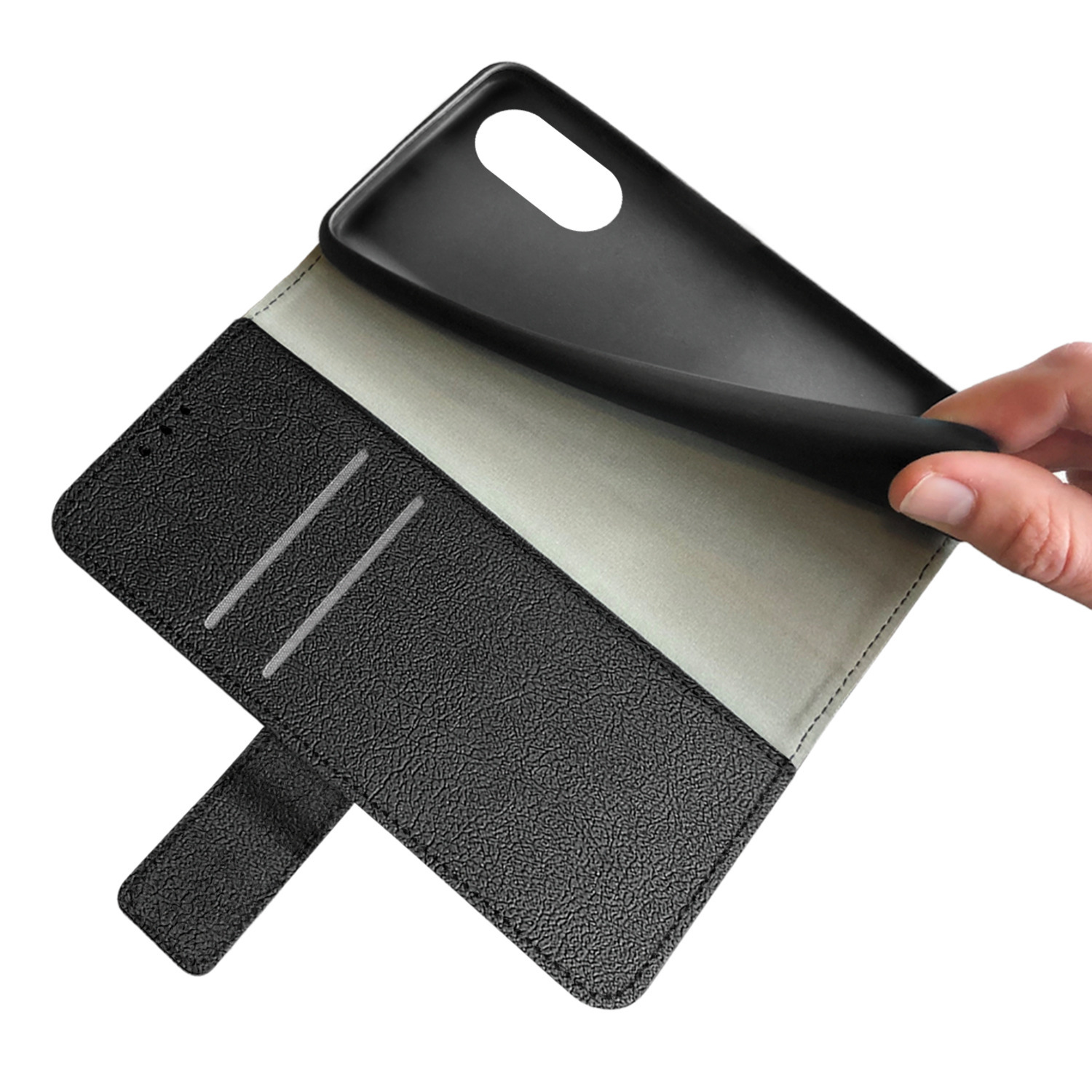 Un étui de téléphone noir est ouvert, montrant un intérieur gris. Une main tient l'étui.