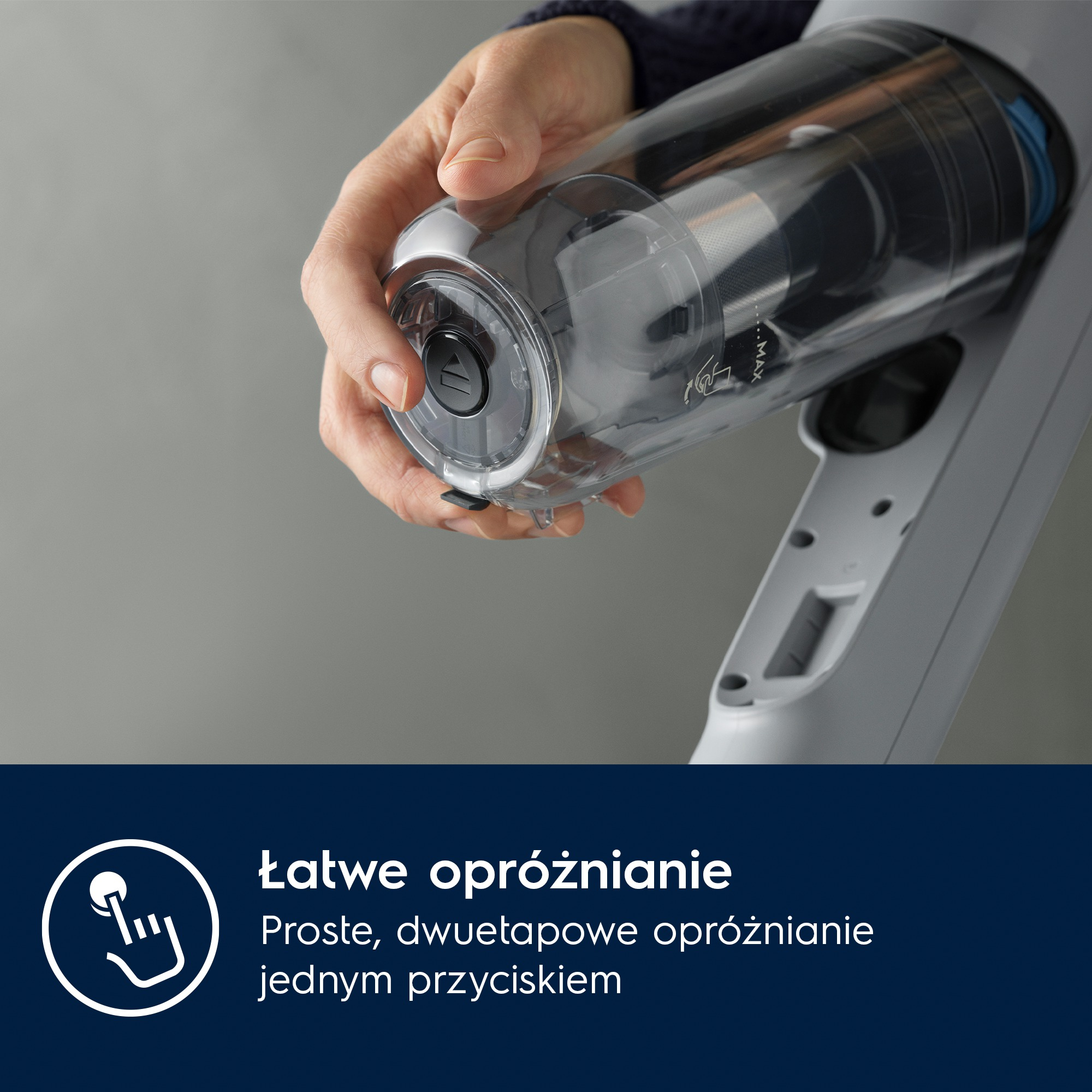 Dłoń trzyma przezroczysty pojemnik na kurz odkurzacza.