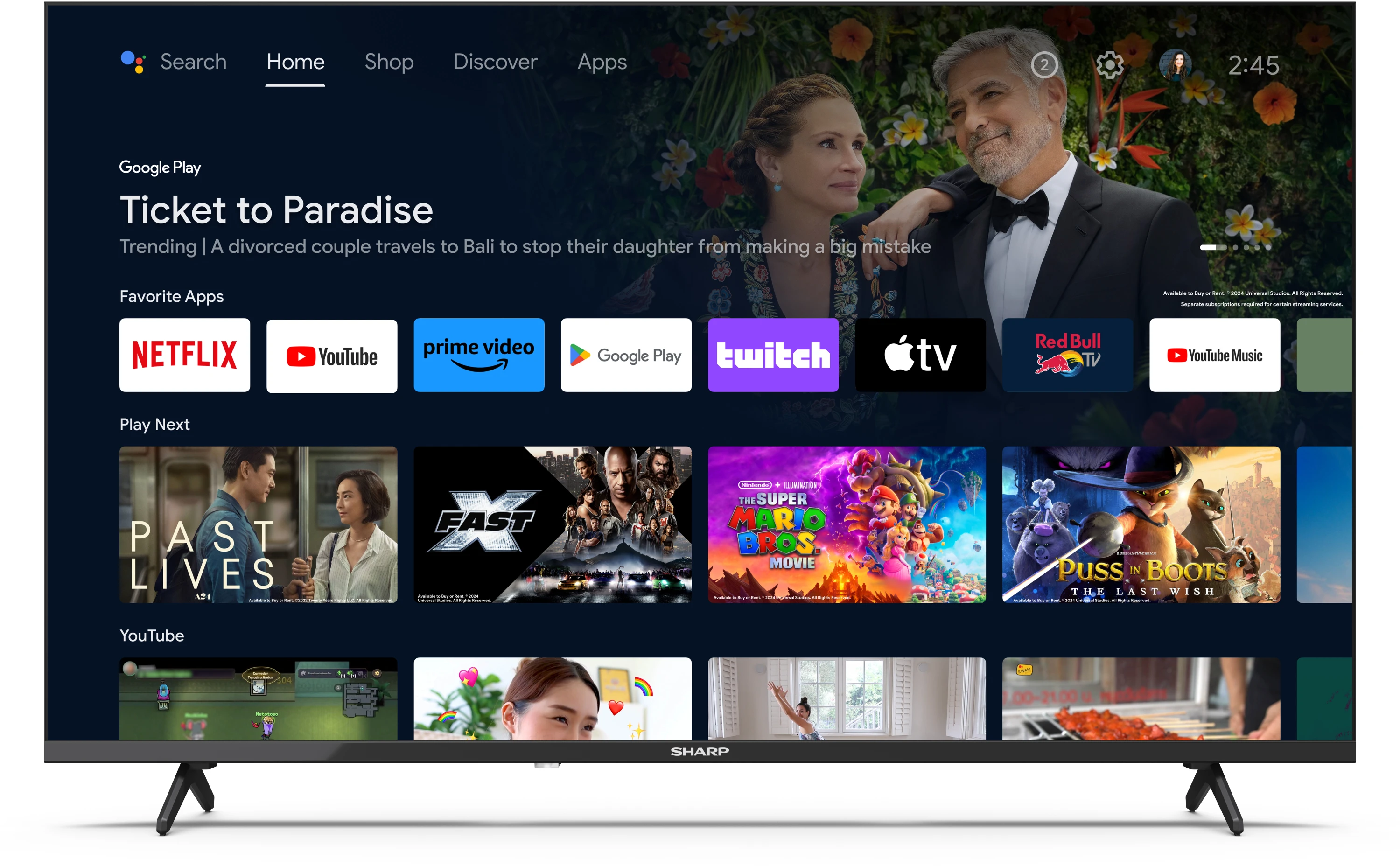 Egy nagyméretű TV-képernyő egy okostévé menüt jelenít meg különféle streaming alkalmazásokkal és filmcímekkel.
