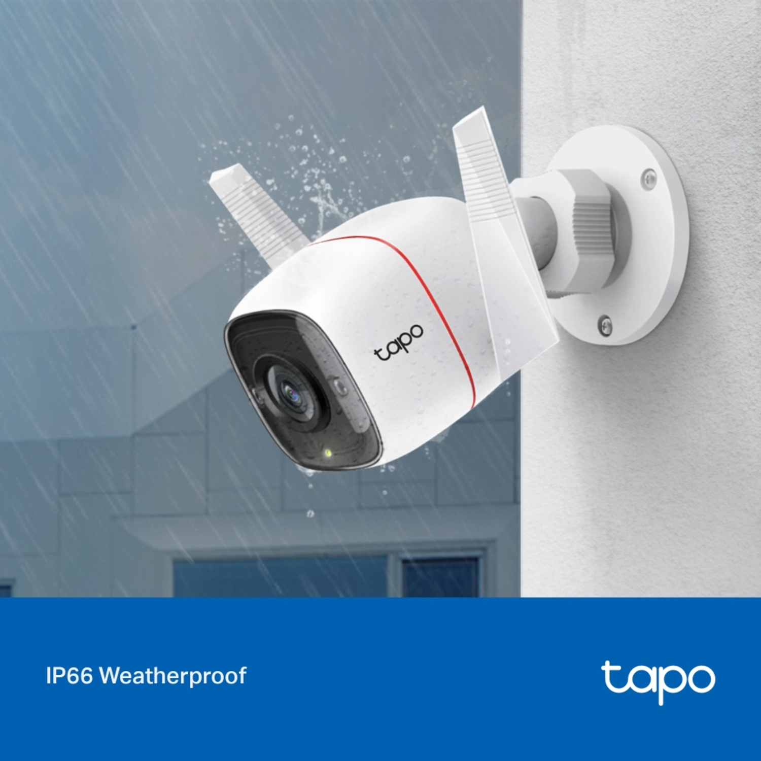 White Tapo security camera mounted on a wall, with antennas, under a rainy sky.