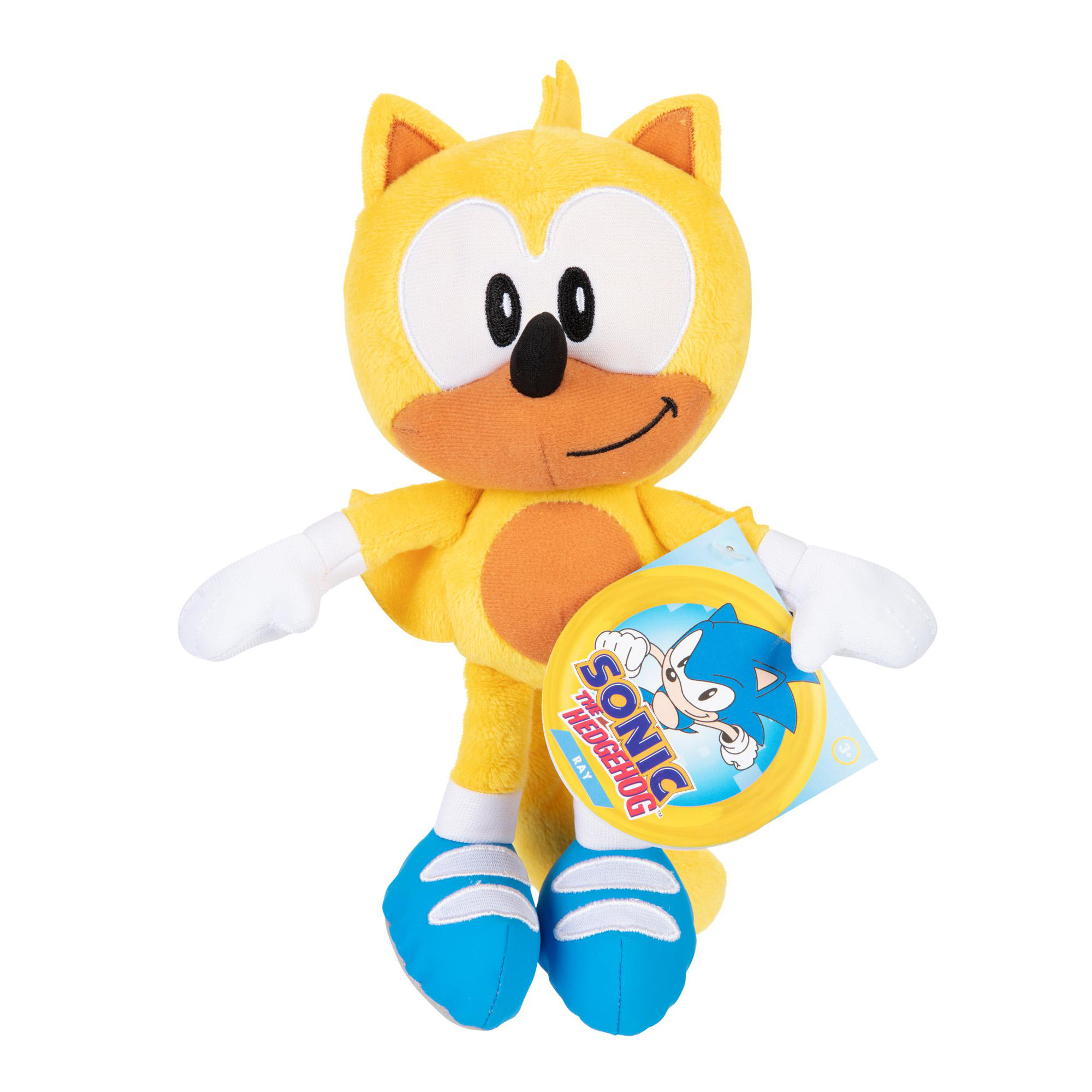 Gelbes Sonic the Hedgehog-Plüschtier, Ray. Lächeln, orangefarbener Bauch. Hält ein blaues Etikett.