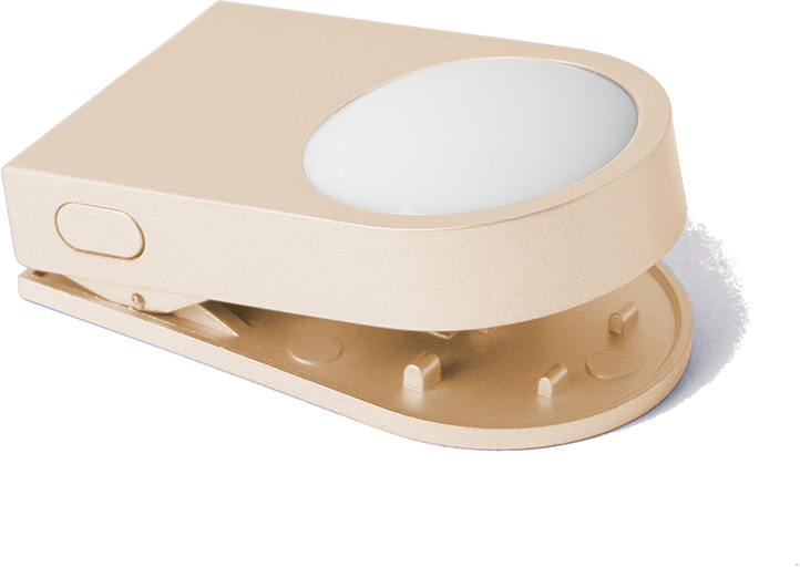 Złoty, otwarty zszywacz z owalnym światłem na górze.