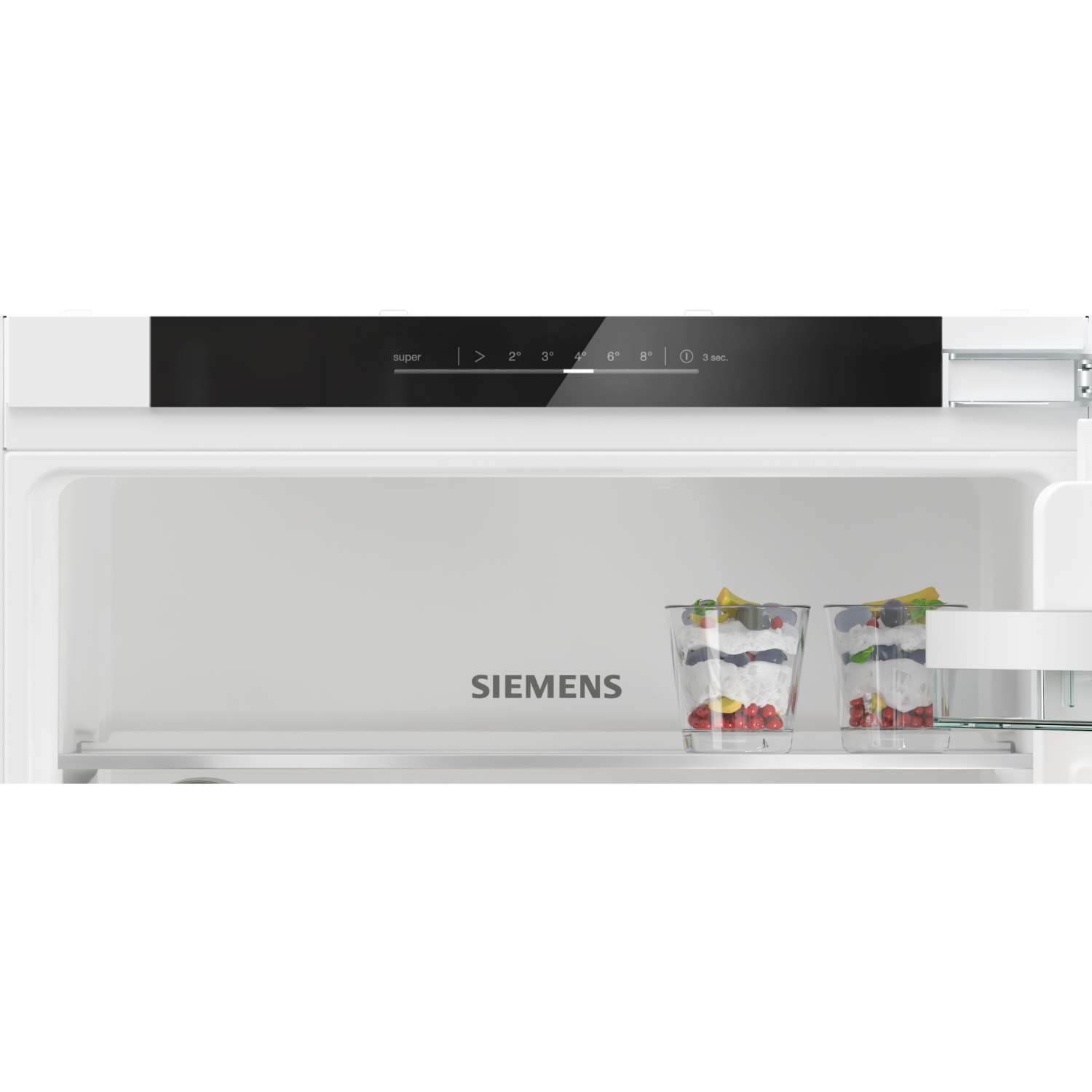 Close-up of the interior of a Siemens refrigerator. There are two desserts in glasses.