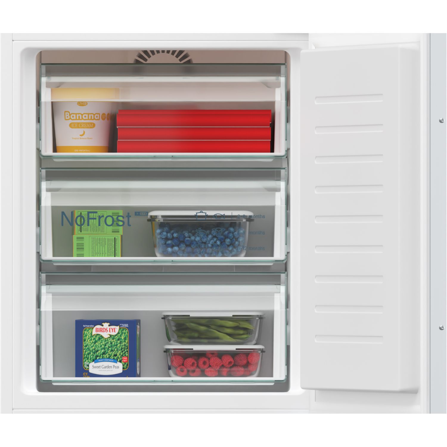 Inside of a freezer with frozen food. Including ice cream, berries, and vegetables. The door is open.