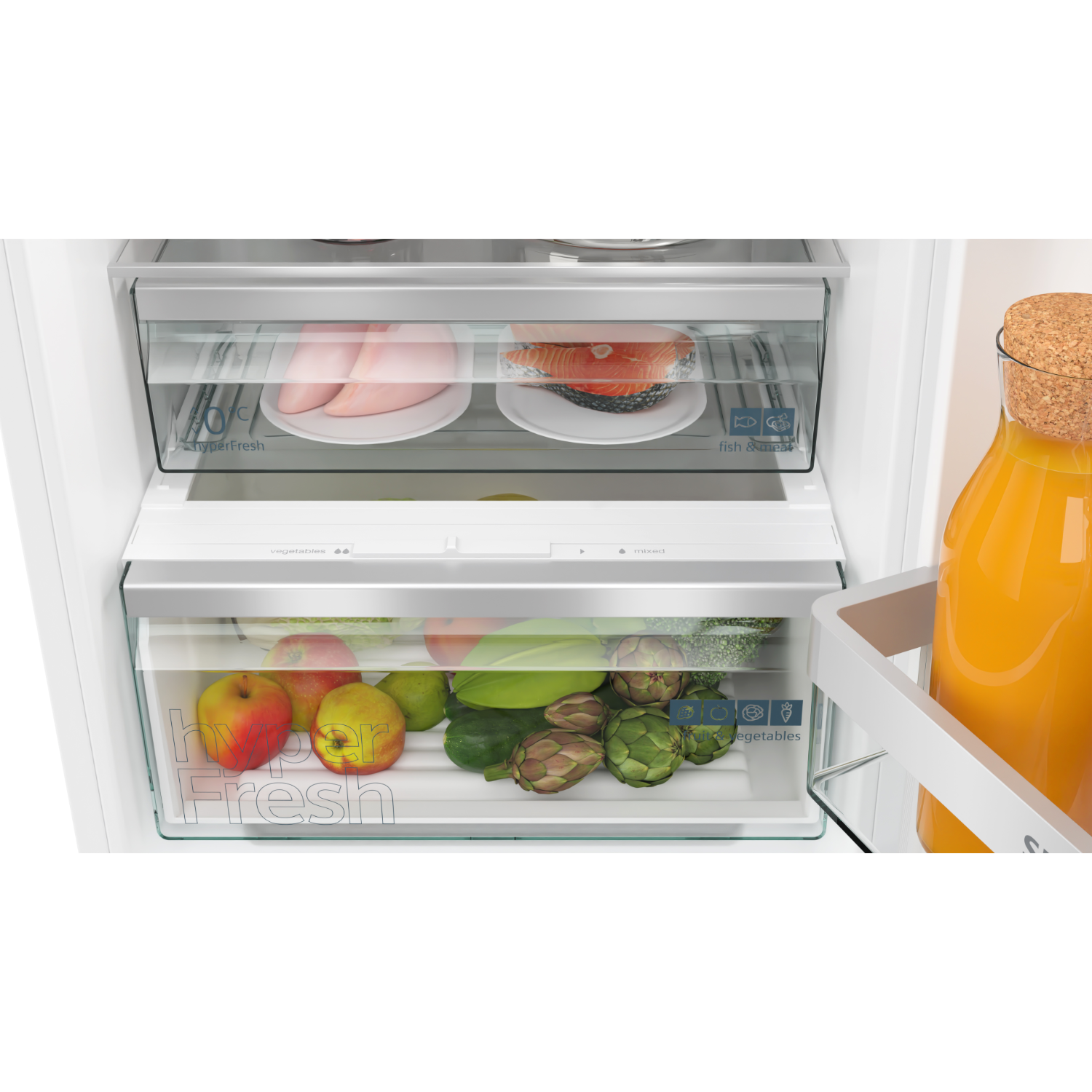 Refrigerator interior with drawers containing food, a jar of orange juice, and a white door.