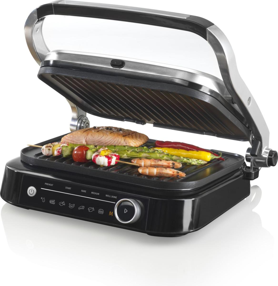 Nyitott elektromos grill főtt ételekkel, beleértve a halat, zöldségeket és garnélarákot.