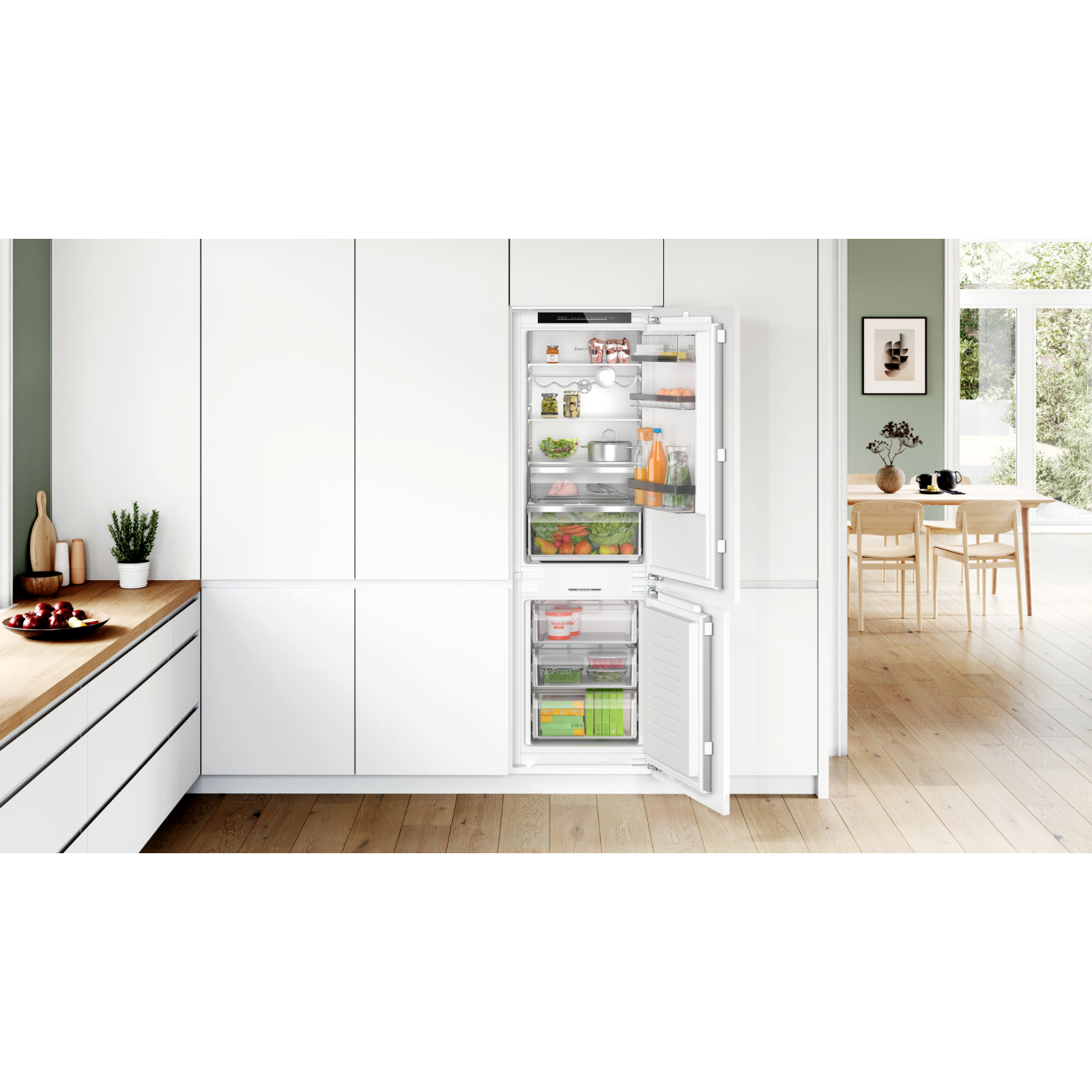 Built-in refrigerator with open doors. Interior view shows shelves with food items.
