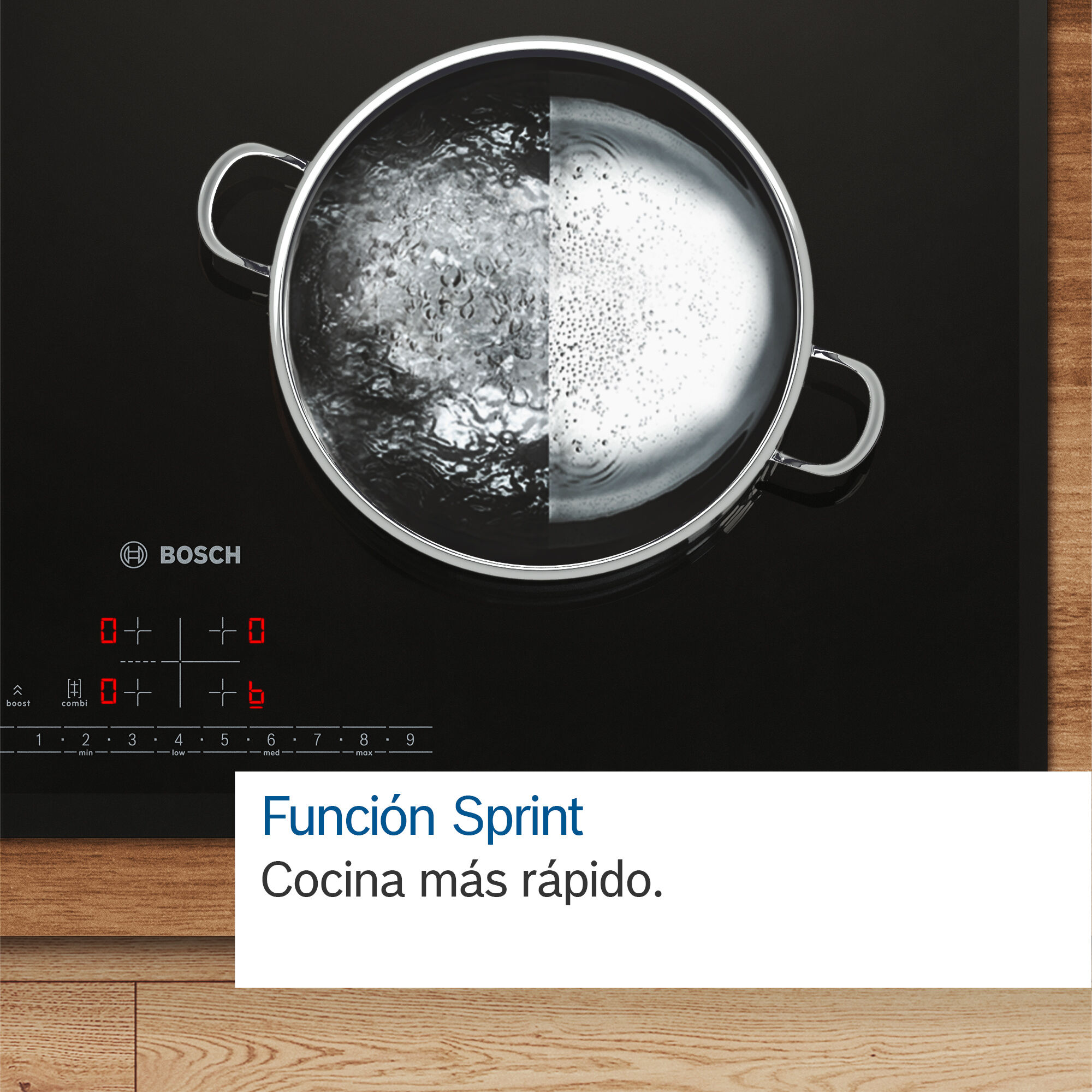 Primer plano de una encimera negra con una olla de agua hirviendo, con panel de control y texto en español.