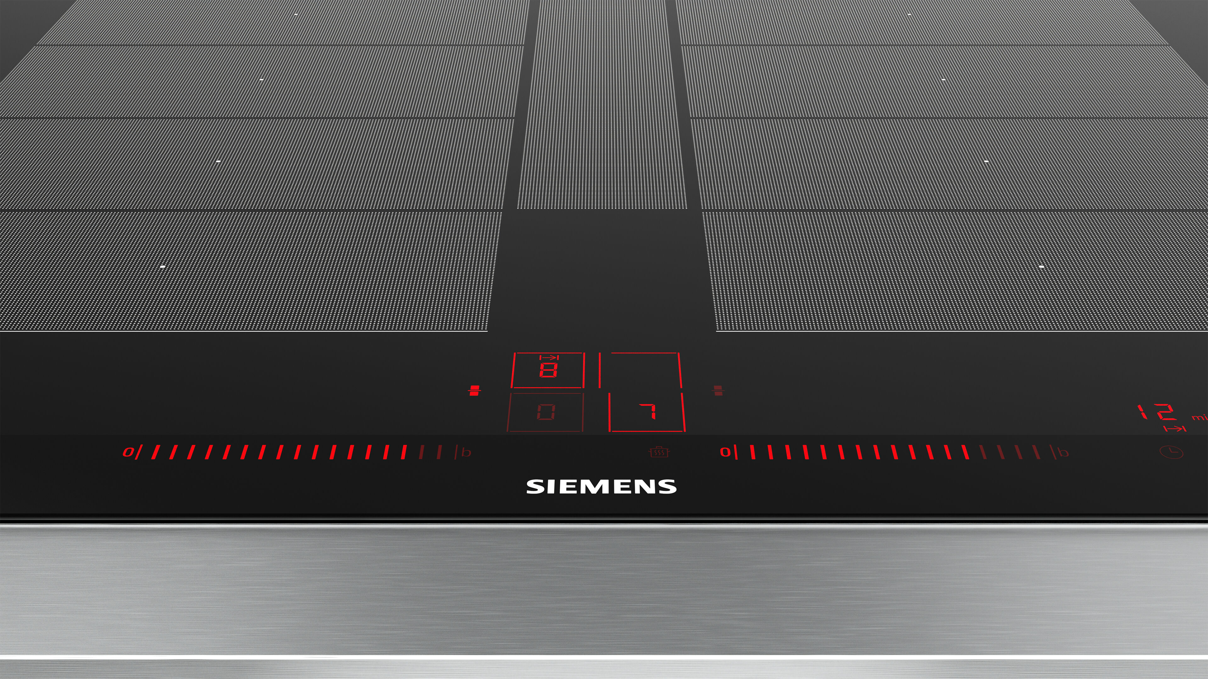 Primer plano de una placa de inducción negra con indicadores rojos iluminados y borde plateado. Logo Siemens visible.