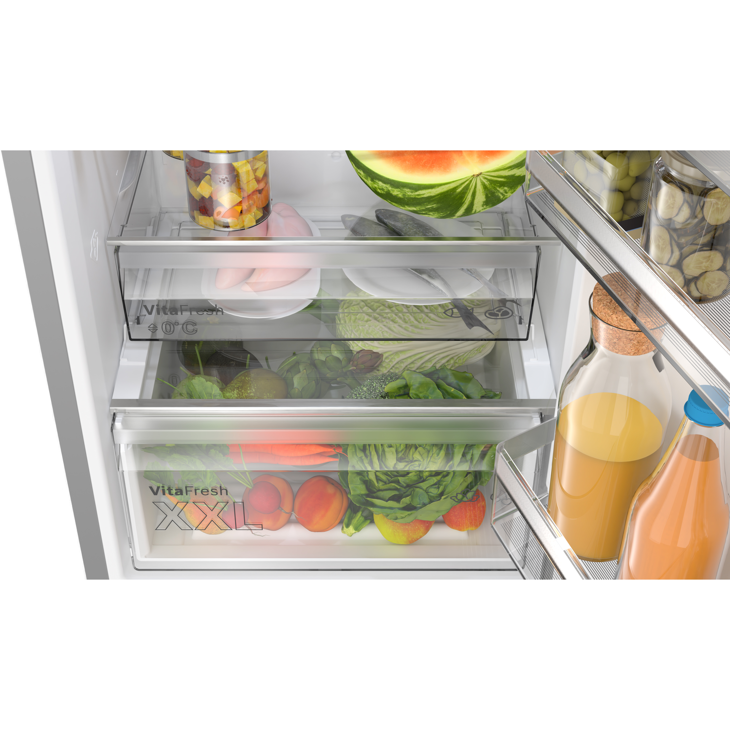 Inside a refrigerator with drawers containing fruits, vegetables, and other food items.