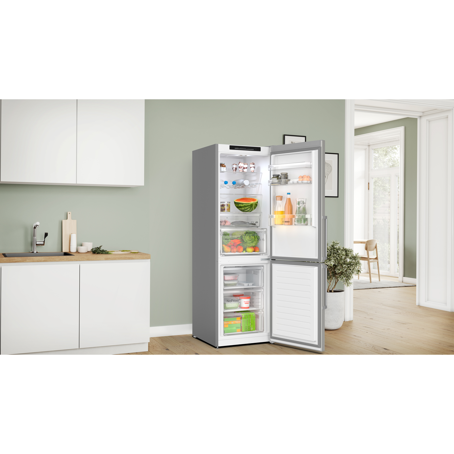 Open, grey refrigerator with food inside, in a kitchen.