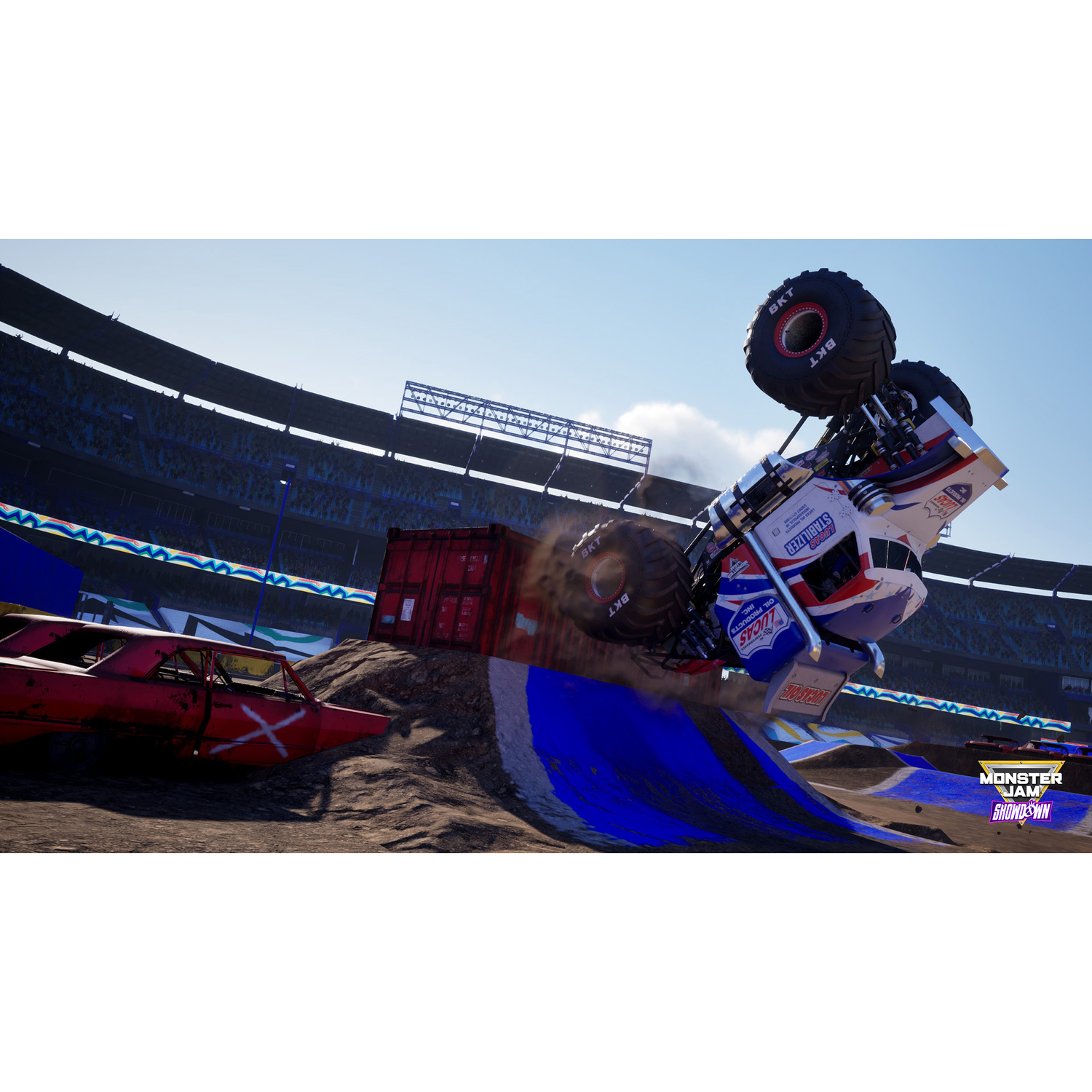 Monster truck in de lucht, kantelt nabij een rode container en een stadion.