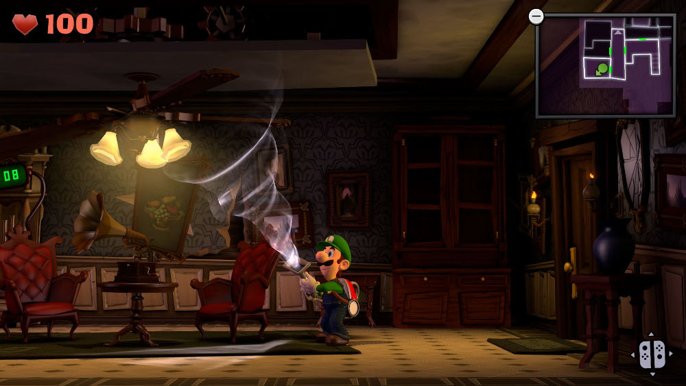 Luigi in a spooky room with a ghost. There's a map and a gramophone in the room.