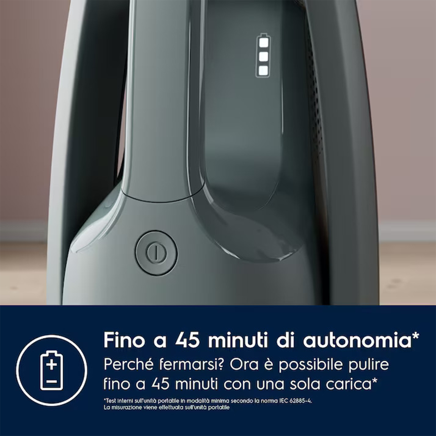 Un aspirapolvere portatile, grigio, con un pulsante di accensione e indicatori di durata della batteria.