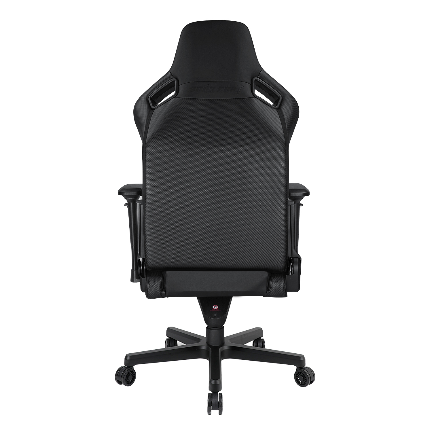 Black gaming chair from the back. It has a headrest, back support with holes, and wheels. The background is white.