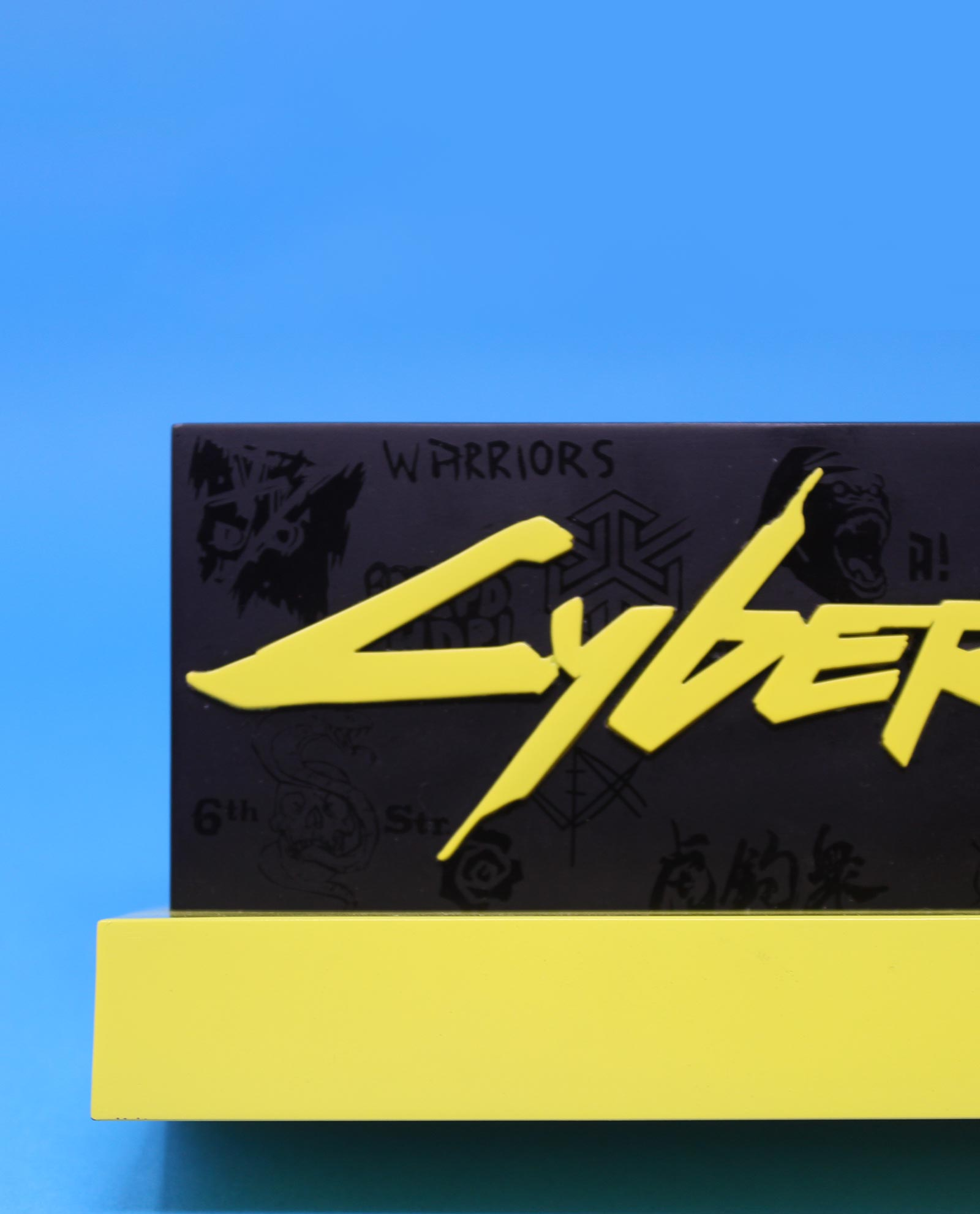 Nahaufnahme eines Cyberpunk 2077-Logos auf einem schwarz-gelben Ständer.